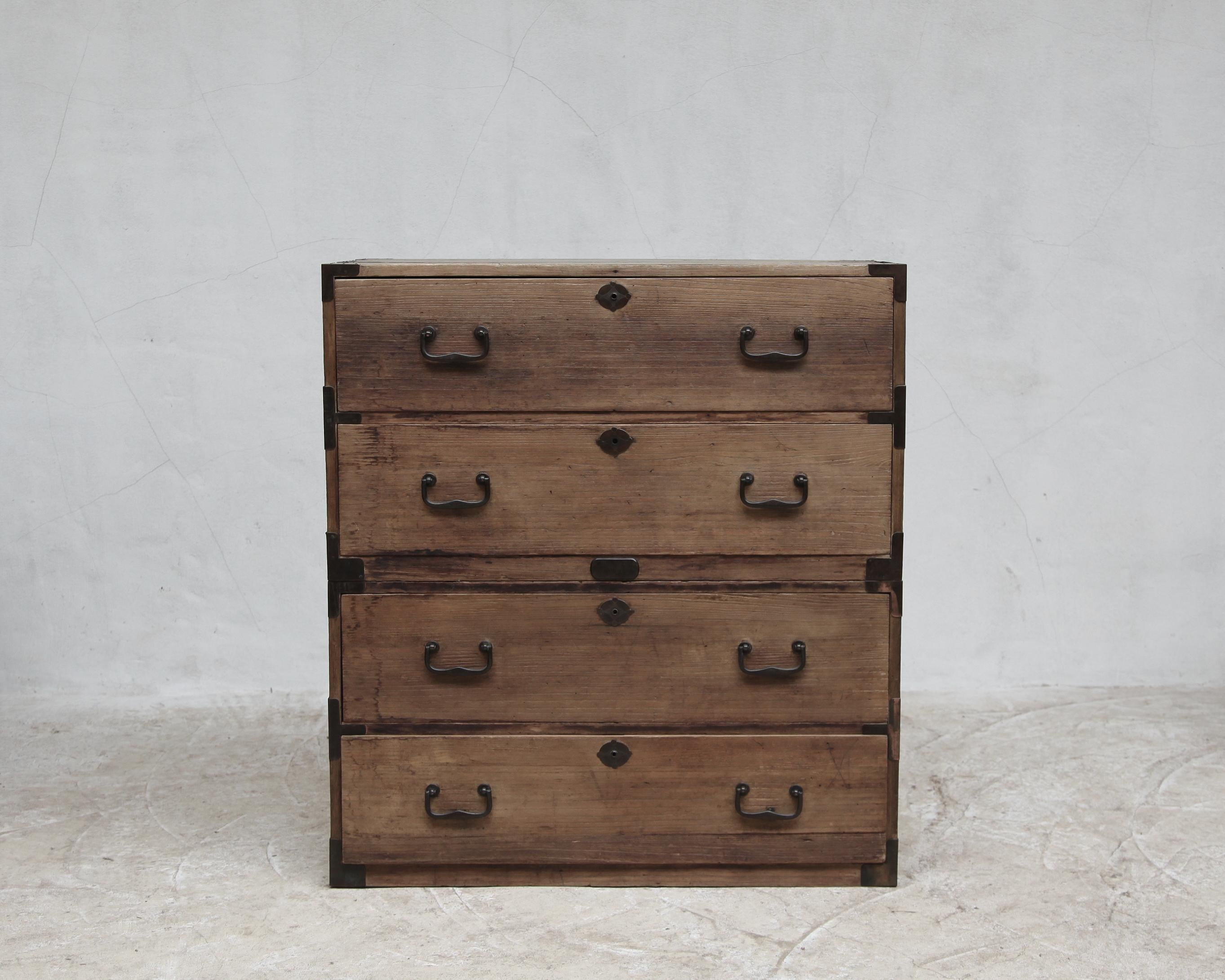 A bleached-out 19th C. (early Meiji) Japanese two part campaign tansu/chest of drawers.

Constructed in cedar (no moths!) with bronze and iron hardware.

Sympathetically restored in our London workshop.