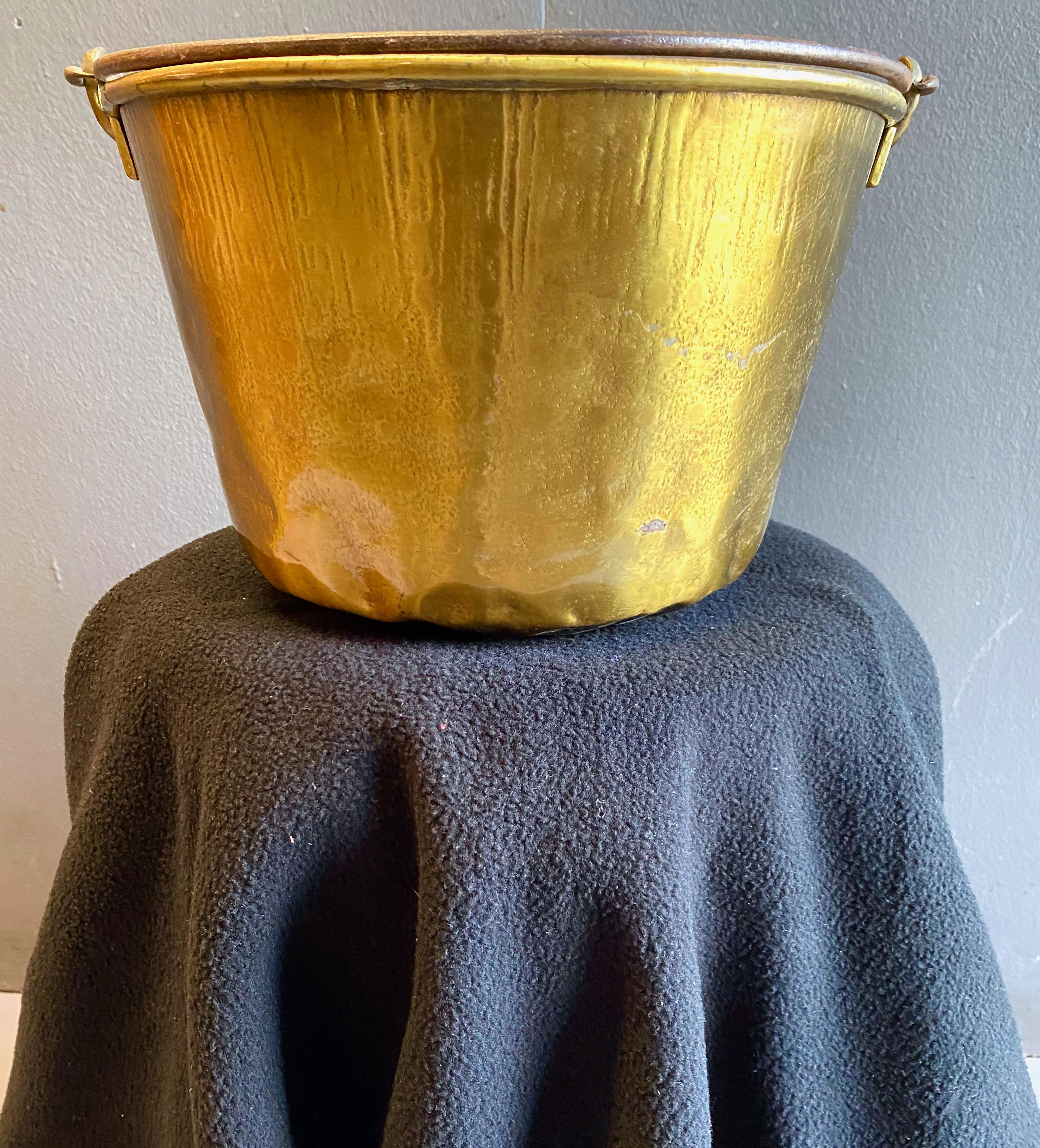 This is a classic mid-19th century spun brass bucket with a forged steel handle.
The bucket is in overall good condition with the normal anticipated dings and patina. The bucket is a great decorative element--especially on Halloween, with Christmas