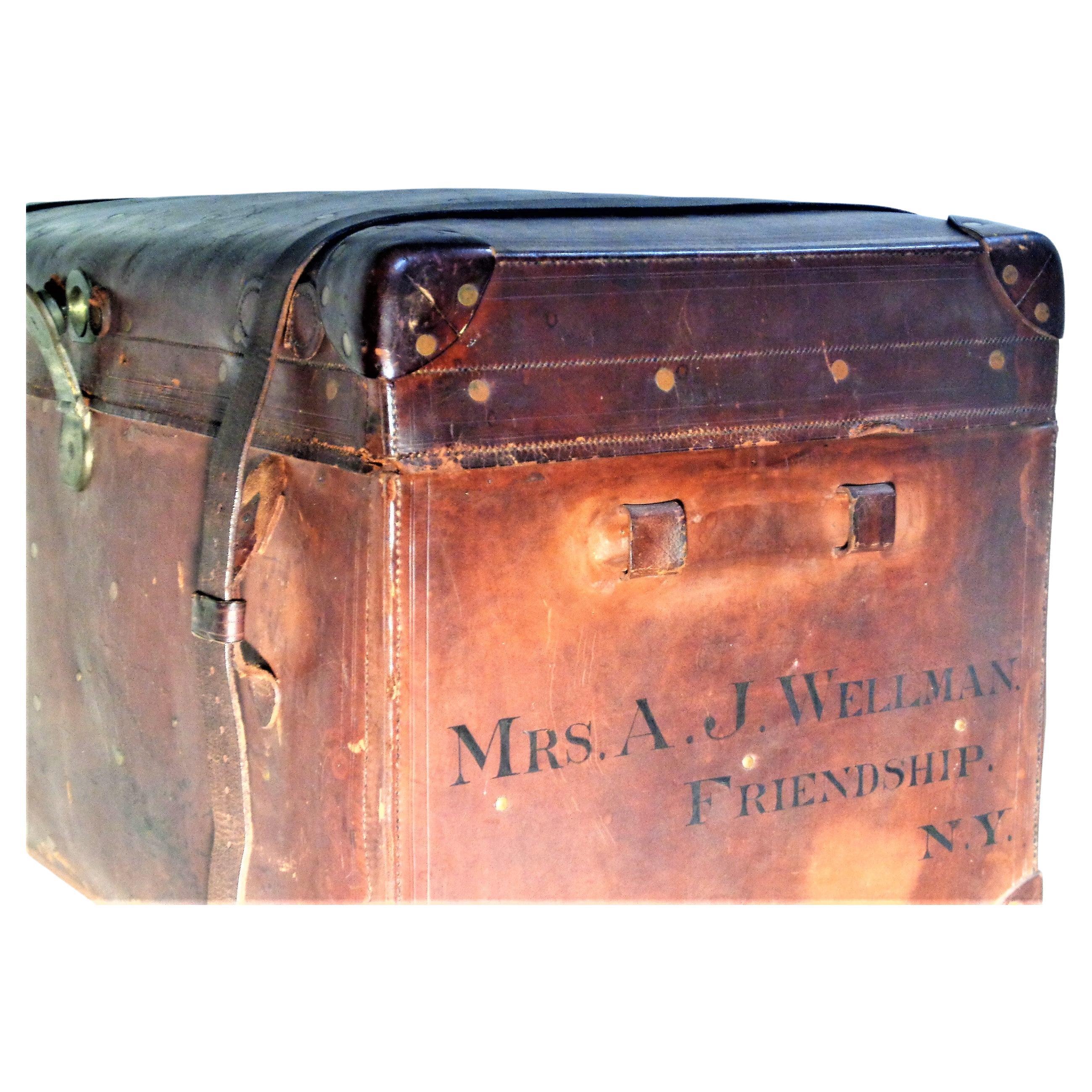A large 19th century American brass riveted leather travel trunk in nicely aged original surface color patina to leather and brass. Ink stamped at both sides with owners name - Mrs. A.J. Wellman, Friendship NY ( information about this historically