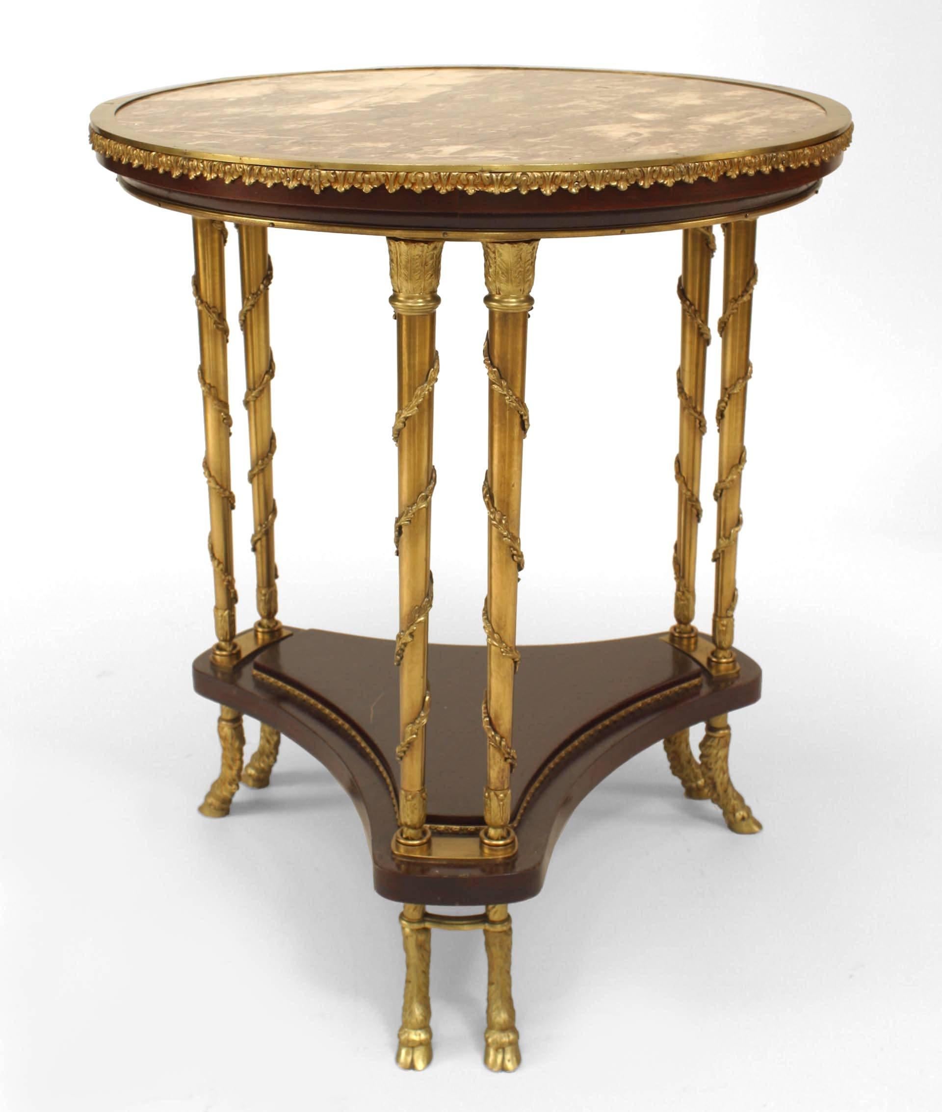 French Charles X style (late 19th Century) mahogany and bronze end table with round inset marble top and mahogany platform shelf with double bronze and trim legs and double hoof feet.
