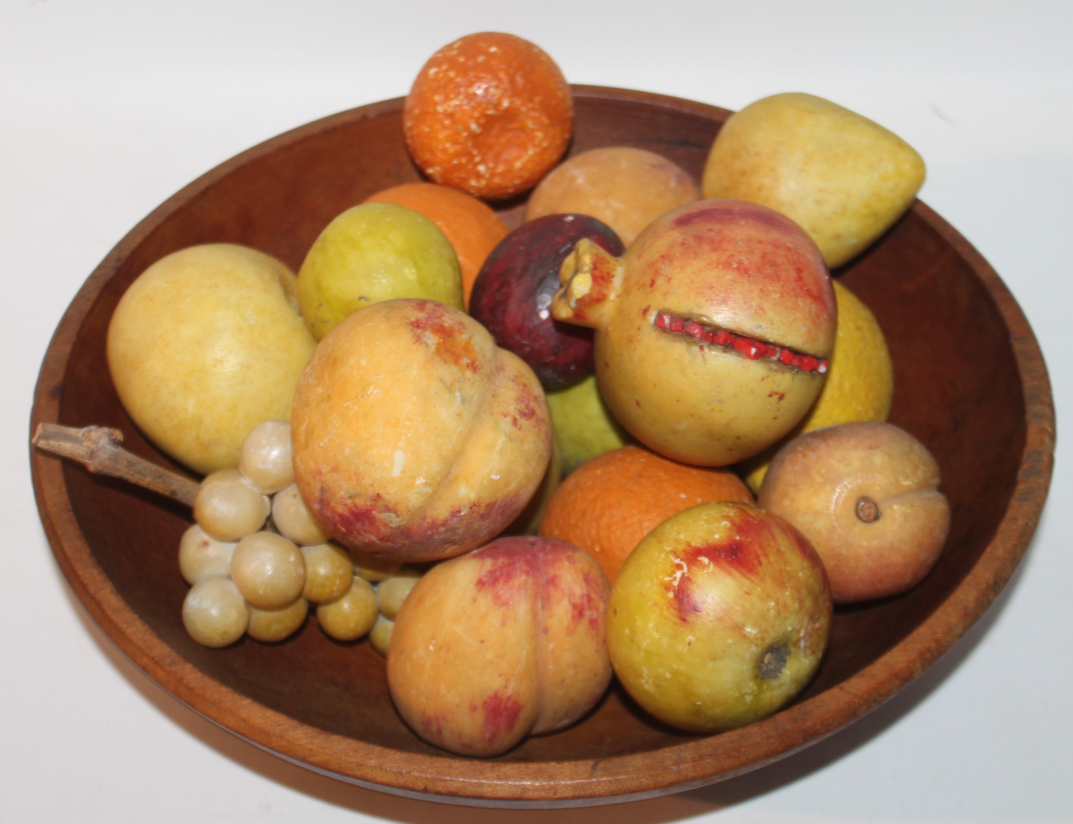 19th C butter bowl and eighteen piece collection of stone fruit. 
Beautiful decorative collection on a table.