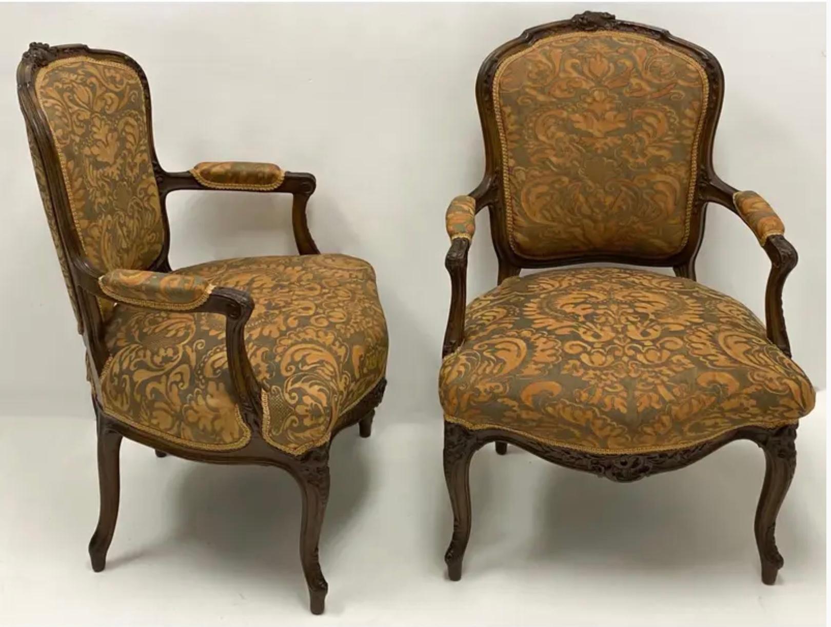 This is a pair of carved 19th-C. French bergere chairs in a vintage silk Fortuny fabric. The frames are carved walnut. The fabric is vintage and in good condition.