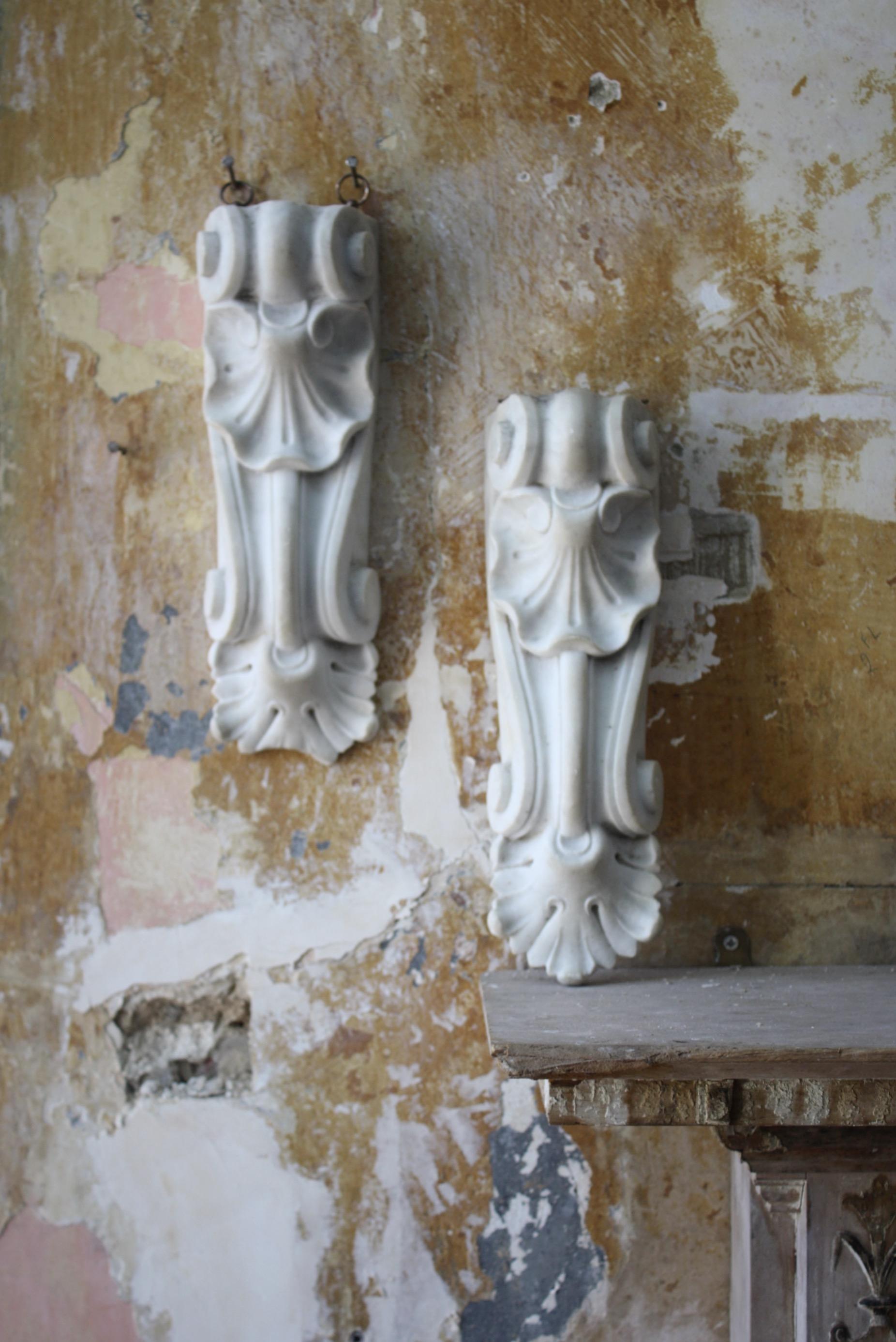 A pair of carved marble elements floral and organic elements , previously part of larger architectural feature like a grand fireplace.

The sections are very well carved and have a good decorative patina, Dating from the early 19th century and