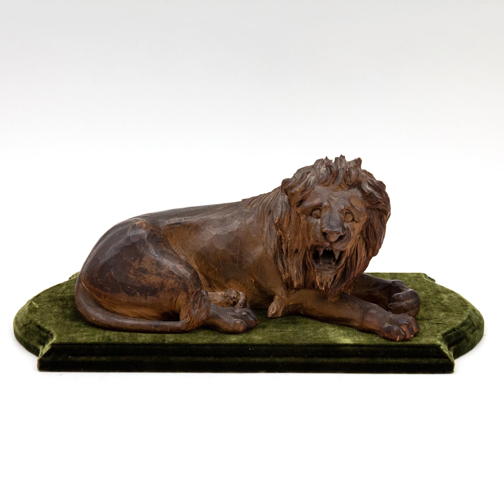 19th Century Carved Wooden Reclining Lion on a Green Velvet Base 7