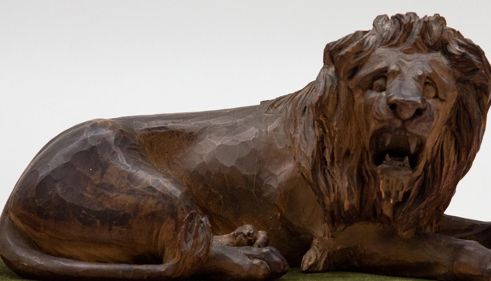 19th Century Carved Wooden Reclining Lion on a Green Velvet Base 1
