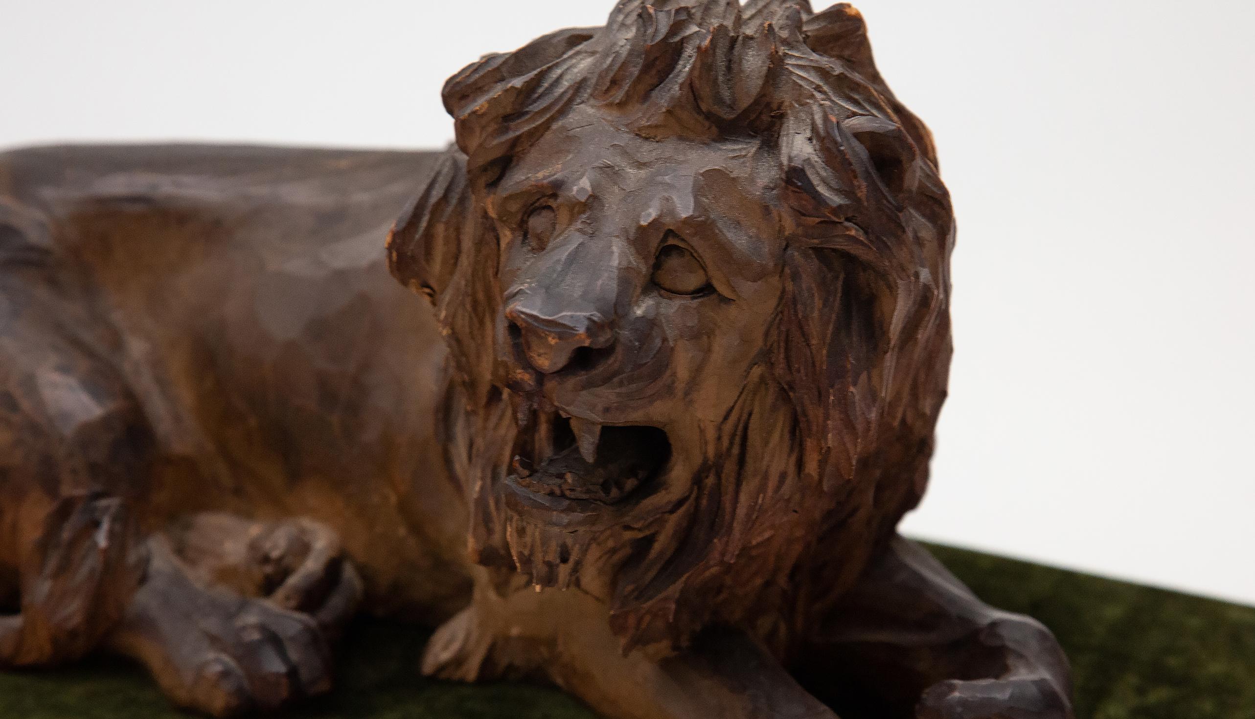 19th Century Carved Wooden Reclining Lion on a Green Velvet Base 2
