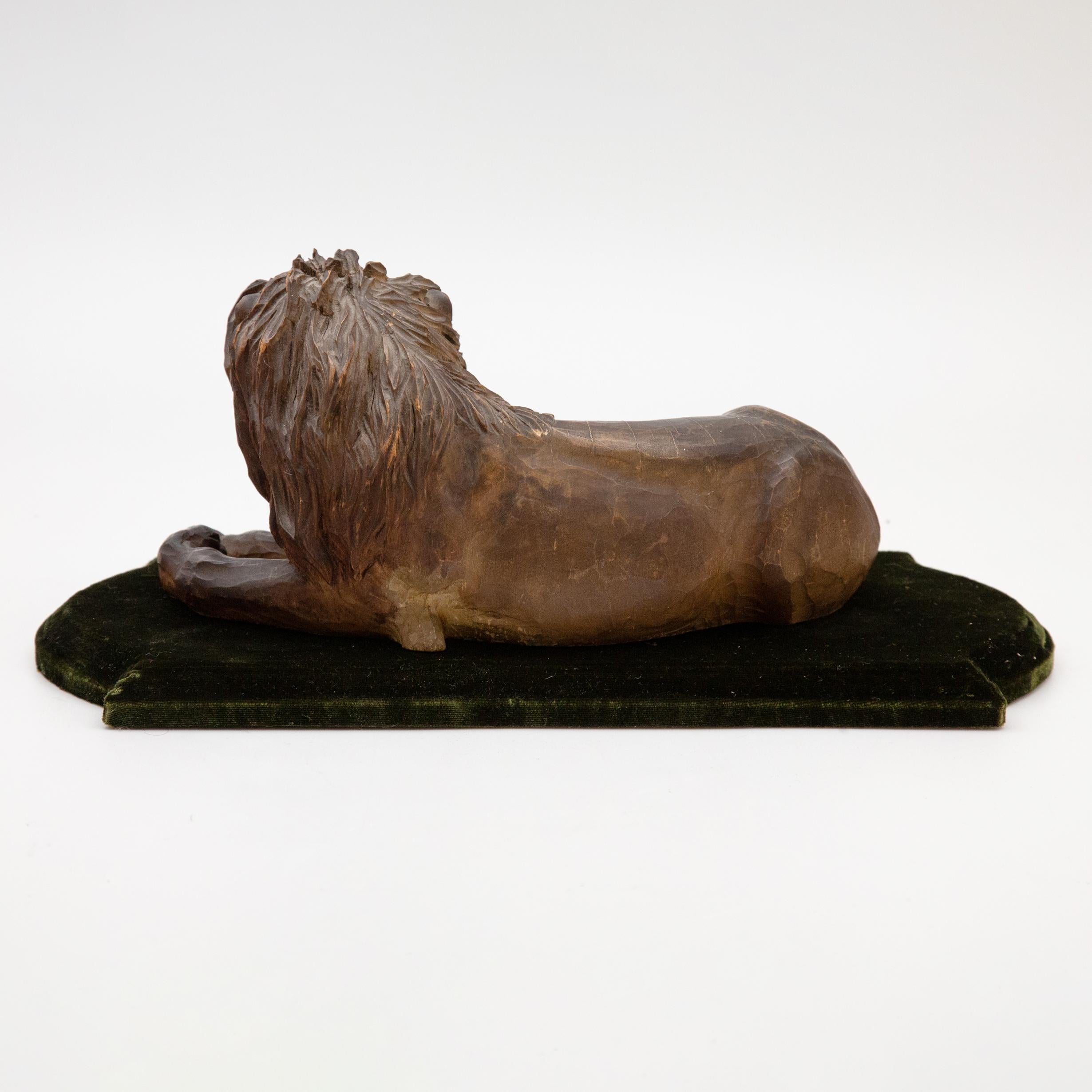 19th Century Carved Wooden Reclining Lion on a Green Velvet Base 5