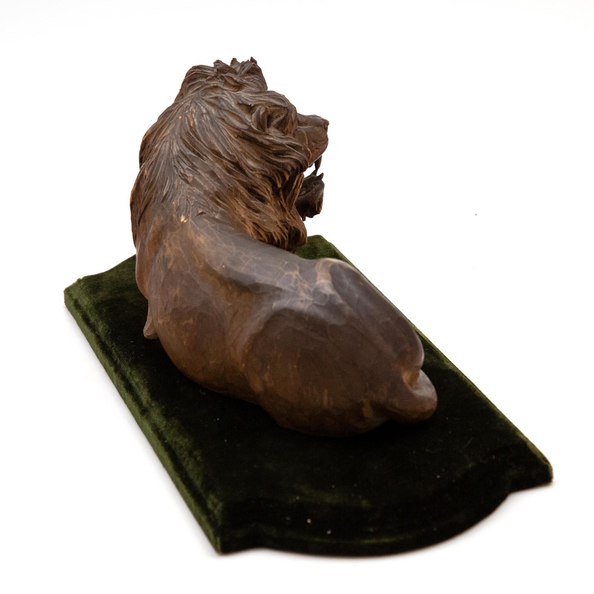 19th Century Carved Wooden Reclining Lion on a Green Velvet Base 6