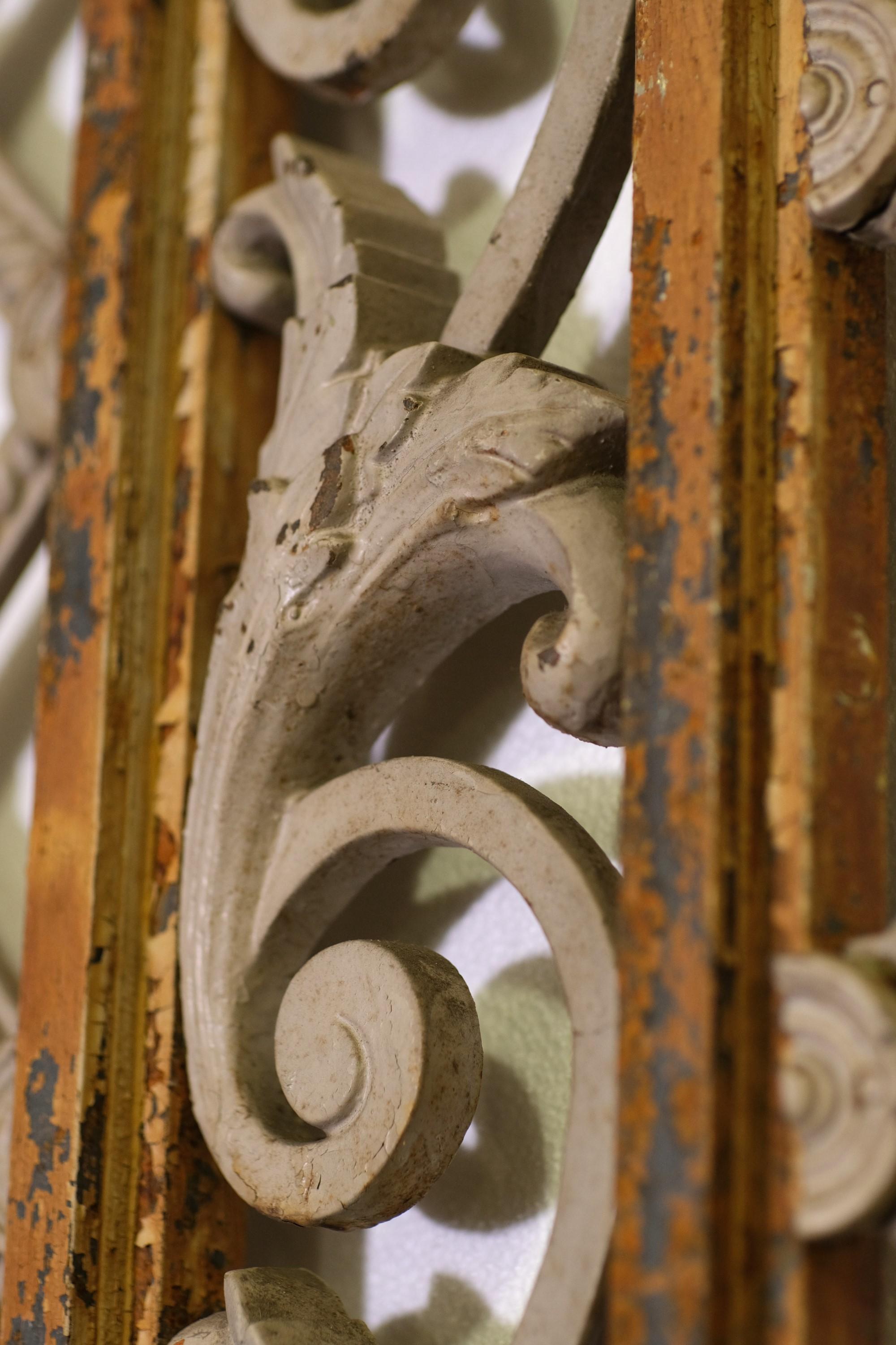 Late 19th Century, cast iron window guard with ornate lattice and floral details enclosed in a steel roman arch frame.  The window grate or guard was reclaimed from a late 19th century hospital in Verona, New Jersey.  There is some of the original