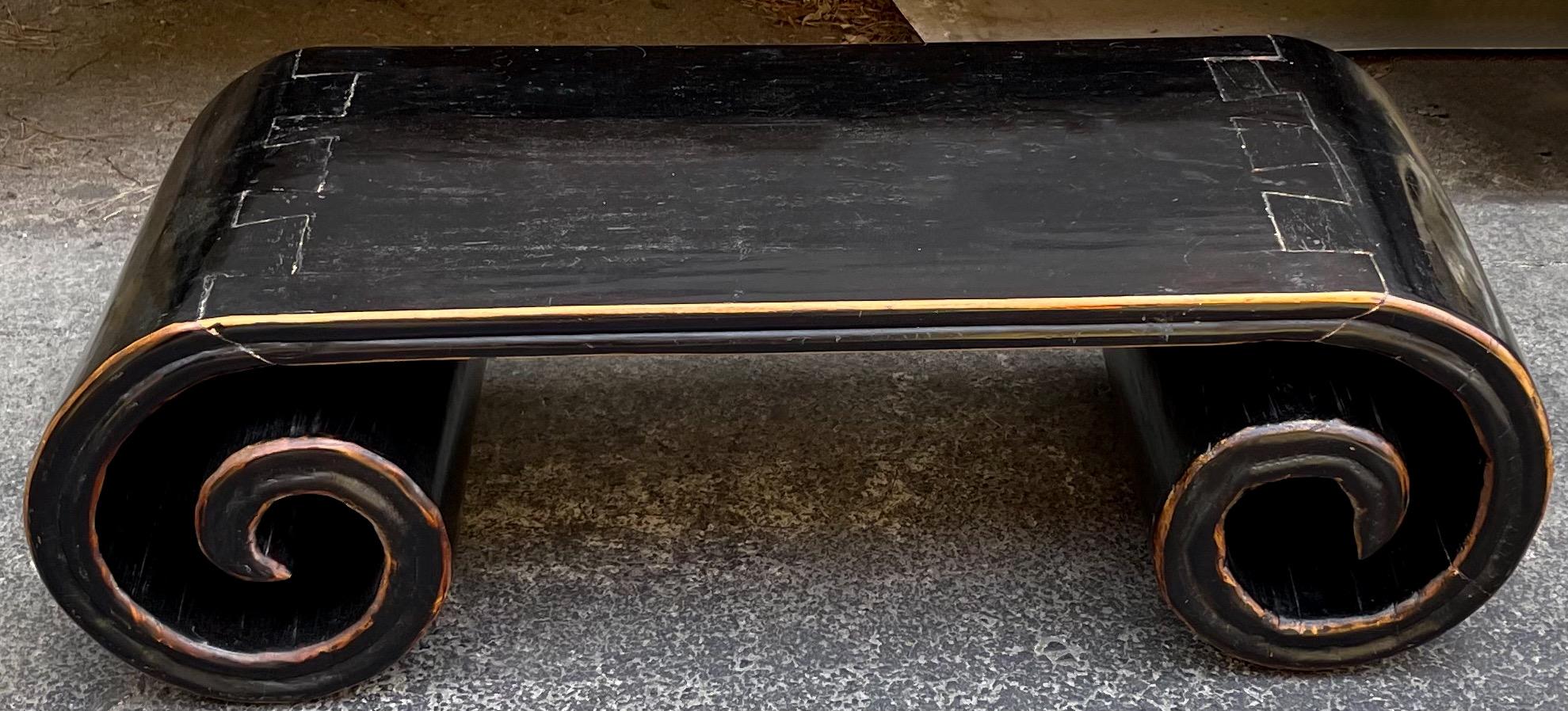 This is a late 19th century Chinese scroll form coffee table made out of elmwood with an ebonized finish. Love the juxtaposition of a 19th century piece with modern flare. Note the dovetailed joints!