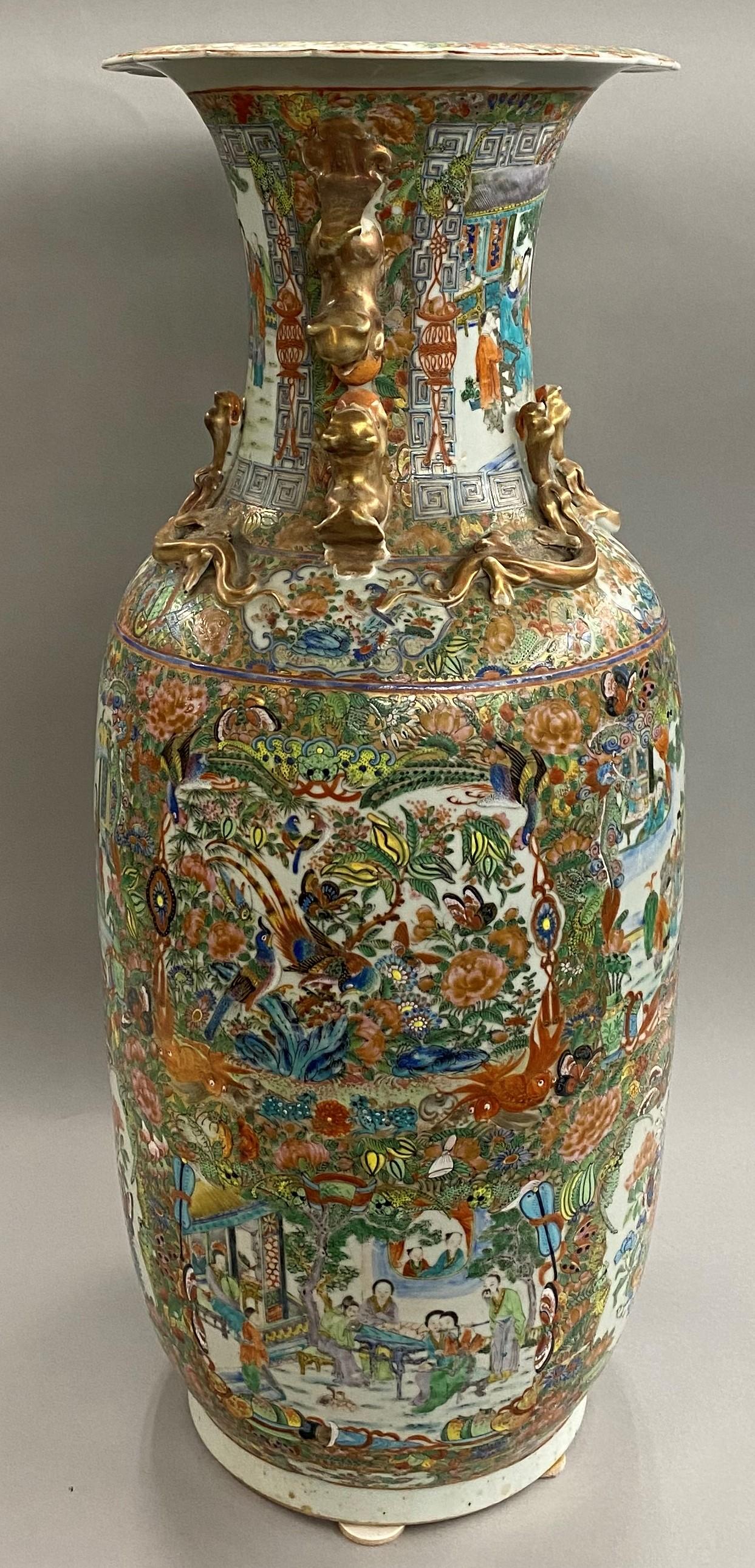 A fine Chinese porcelain polychrome rose medallion palace size baluster form vase with multiple panels of figures, birds, and flowers, along with applied foo dogs and serpents around the neck, and scalloped rim. Dates to the 1830s or 1840s in very