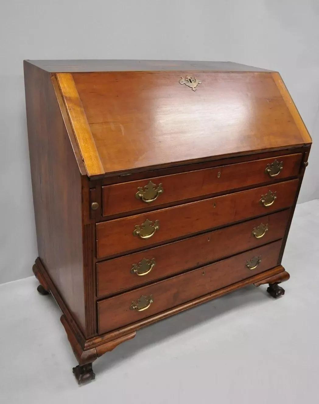19th Century Mahogany Slant Front Carved Ball & Claw Chippendale Style Desk. Item features dovetail joined top and bottom, solid wood construction, beautiful wood grain and patina, 9 dovetailed drawers, carved ball and claw feet, solid brass