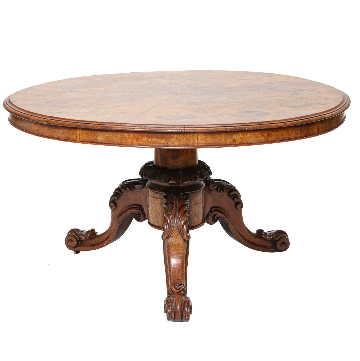 19th century circular walnut tip top center table with burl veneered pie crust top and base having a carved column on three cabriole legs with acanthus carved knees and carved scroll feet, circa 1860-1870. 52