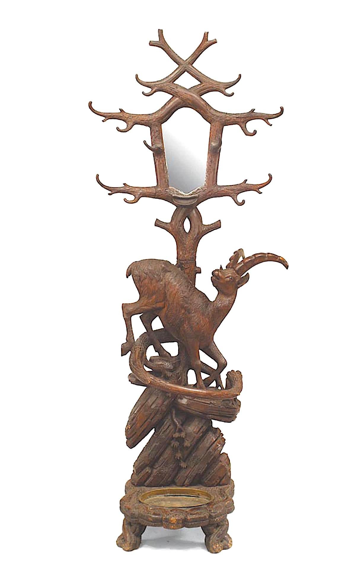 Rustic Black Forest (19th Century) carved walnut hatrack/umbrella stand with ibex on base and mirror with small shelf on upper section.
 