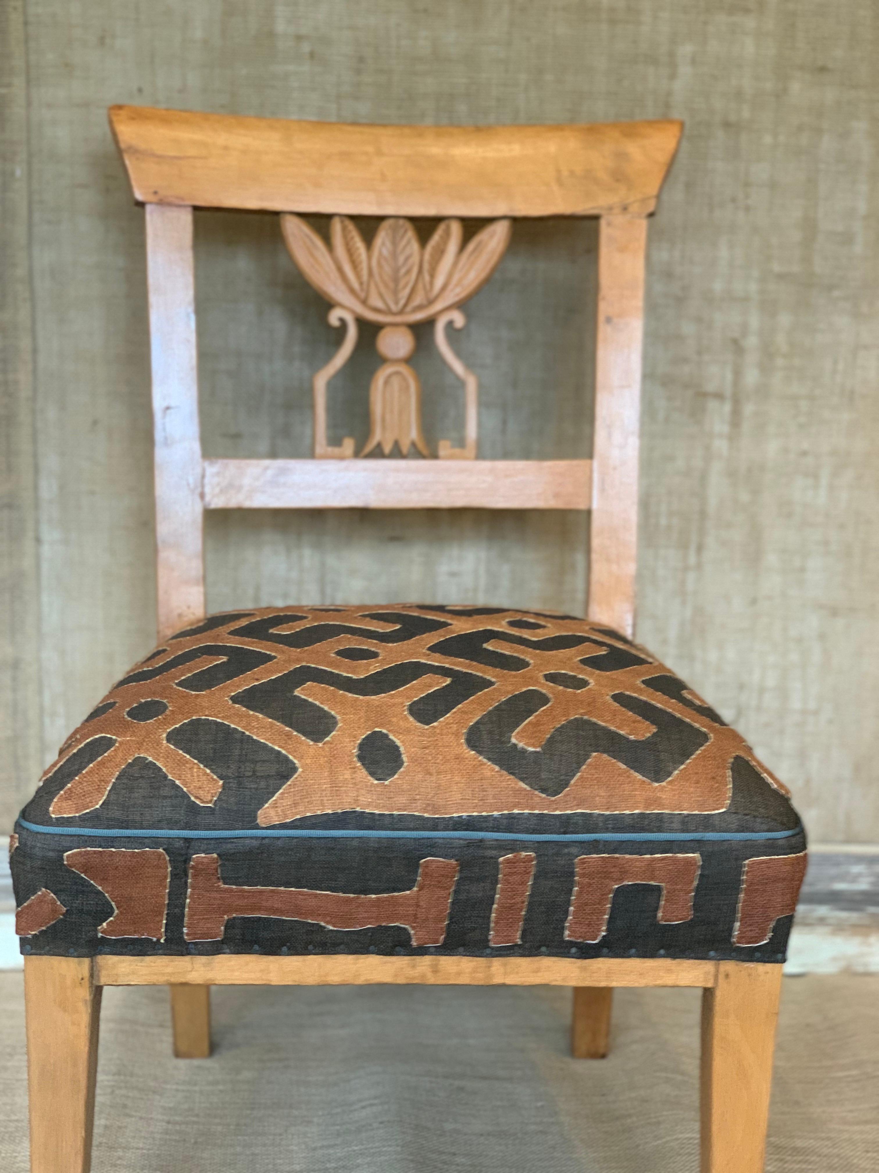 A 19th Century Continental diminutive Side Chair in Fruitwood, upholstered in Vintage African Kuba Cloth.