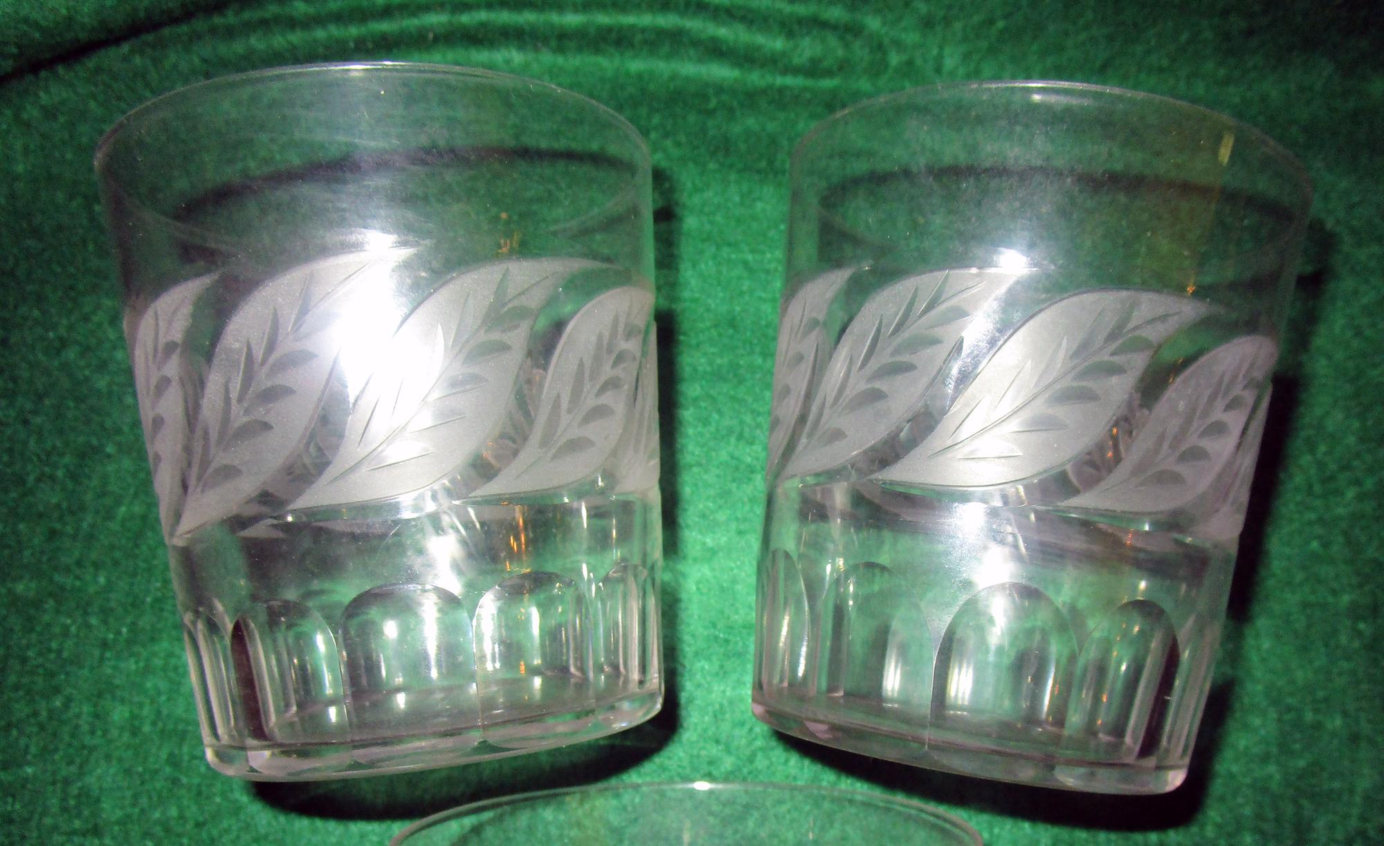 From an old Savannah estate, this set of six early 19th century cut crystal julep glasses feature etched mint leaves surrounding the tops and a thumbprint design around the beveled bottoms. A very good quality early set with a nice 