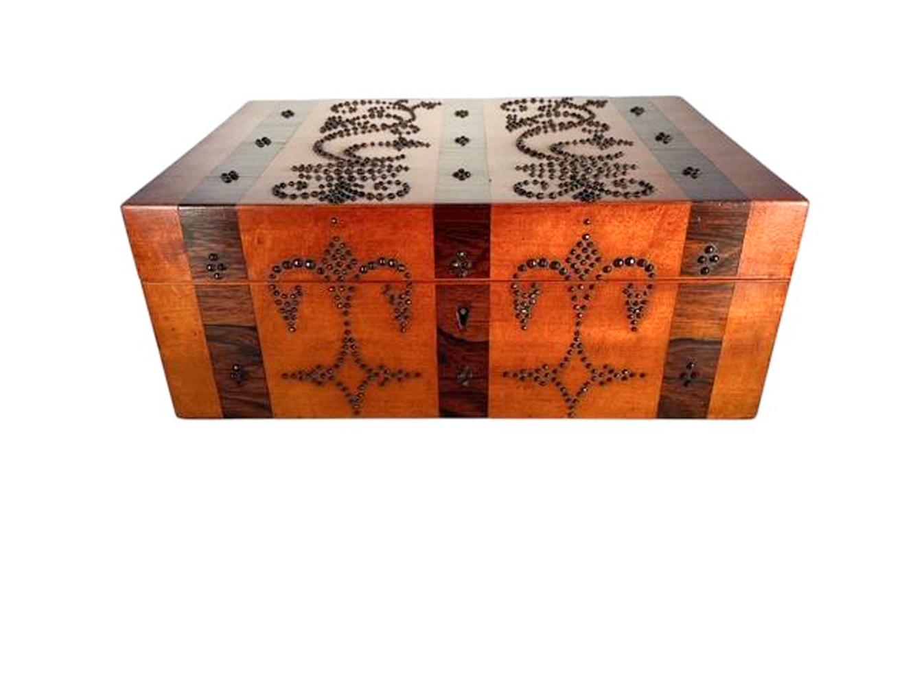 Palais Royal satinwood jewelry box with inlaid rosewood bands and cut steel tack-head decoration. Three rosewood bands running front to back across the top and continuing down the back and front separating panels of satinwood decorated with