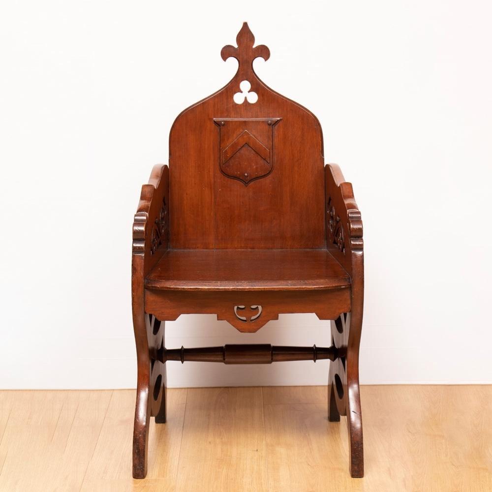 A really good example of a 19th century ecclesiastical Gothic Revival Priests' chair, with fretted sides and central crest.

A nice quality signature piece.