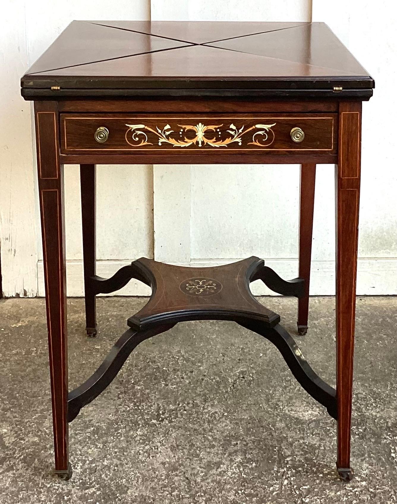 Detalles Cerrar
Descripción
Mesa de juegos con tablero plegable y pañuelo de palisandro eduardiano del s. XIX. Esta mesa mide 22 pulg.² cerrada por 29 pulg.² de altura abierta mide 30 1/2 pulg.². está en magníficas condiciones con tablero de cuero