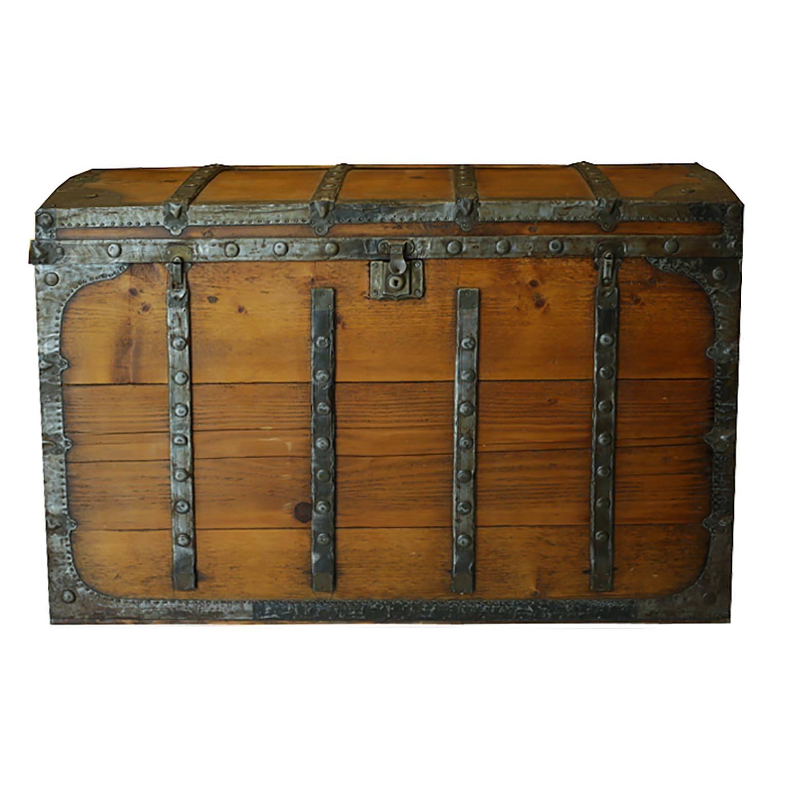 Elmwood trunk with tin straps, circa 1800s. The interior is lined with wall paper which can be removed.