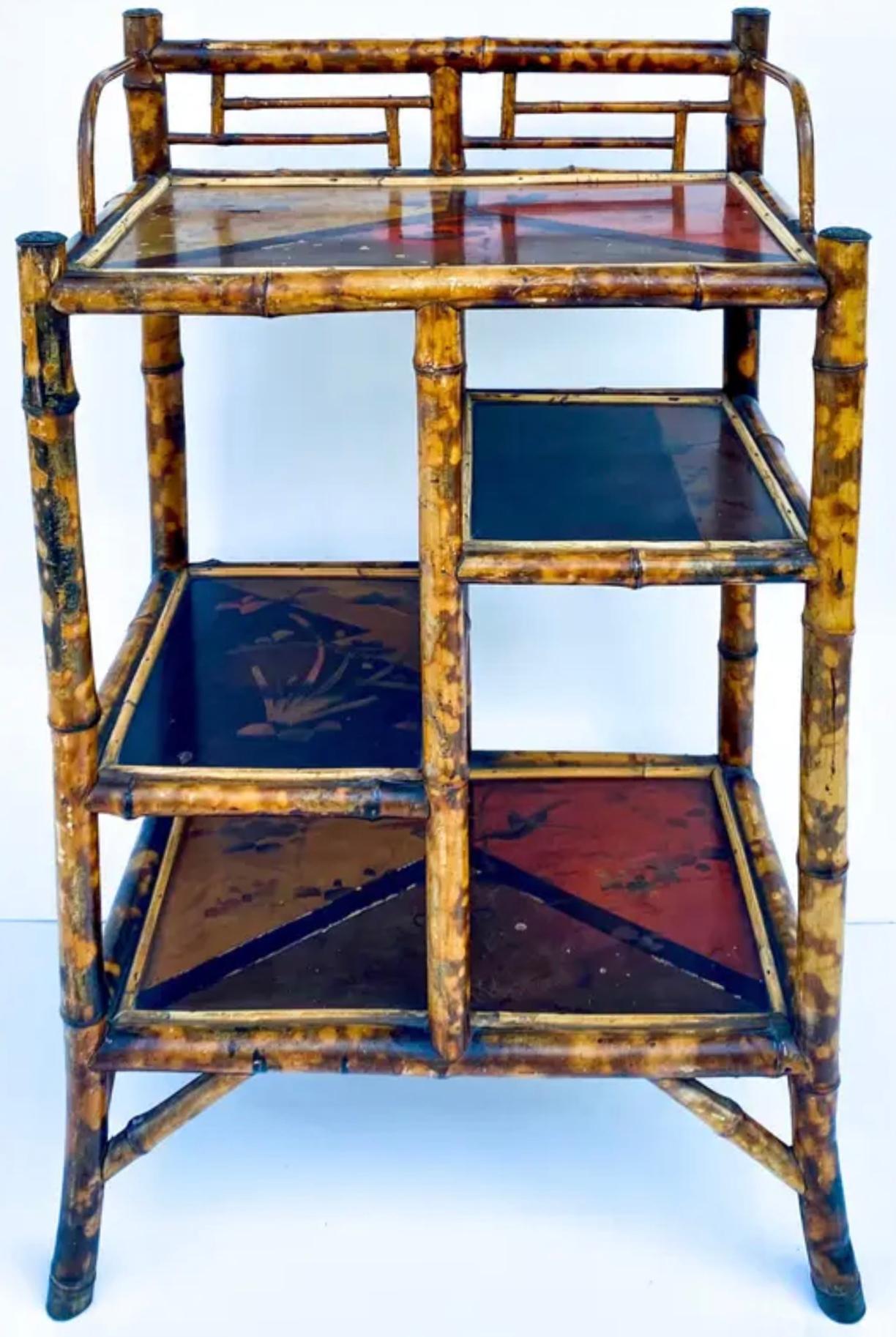 This is a late 19th century English burnt bamboo shelf or plant stand. It has lacquered shelf surfaces with Aesthetic movement nature themes. It is in very good condition.