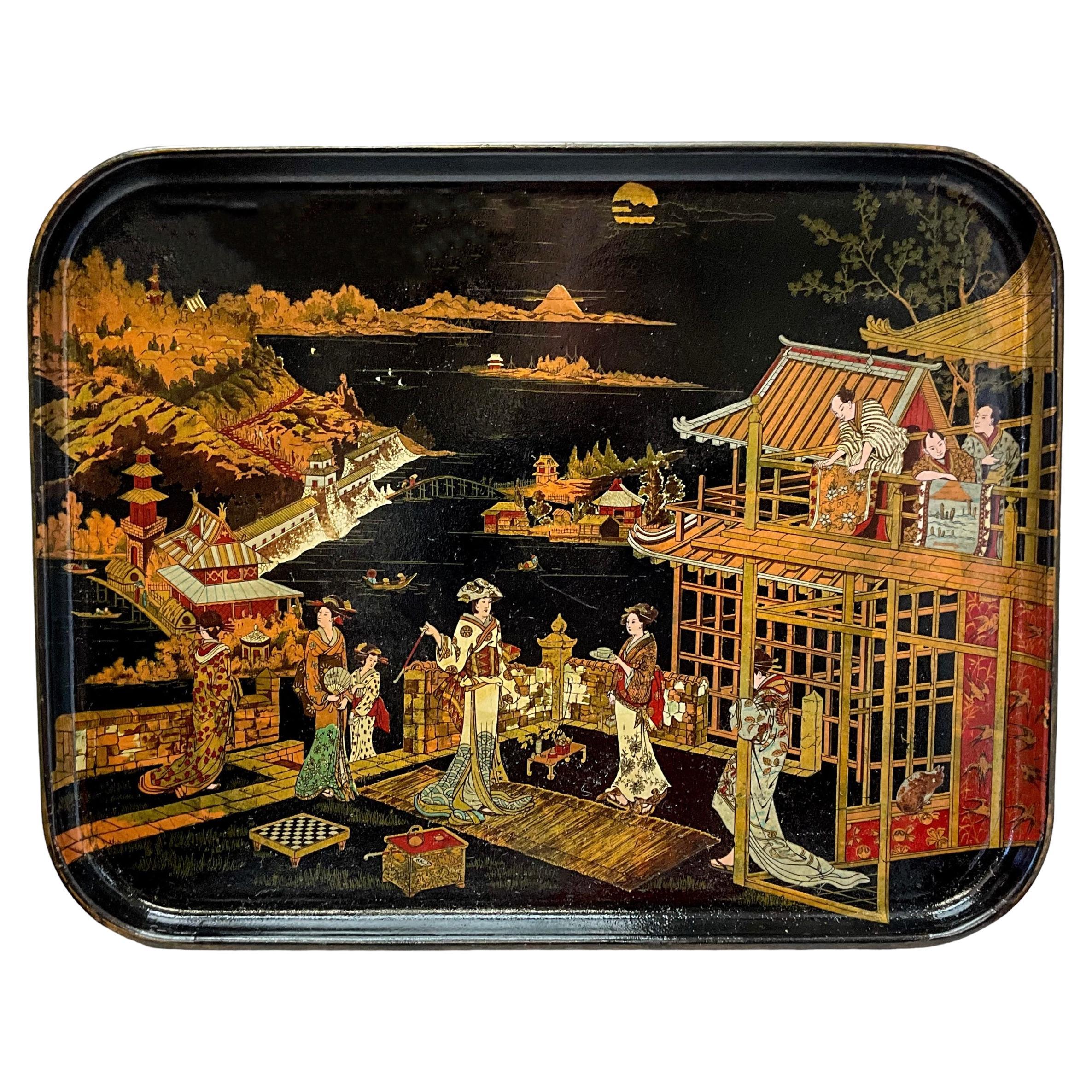 This is a late 19th century English regency black lacquer and gilt chinoiserie papier-mâché tray. The Japanning depicts pastoral and coastal scenes. It is in very good condition,