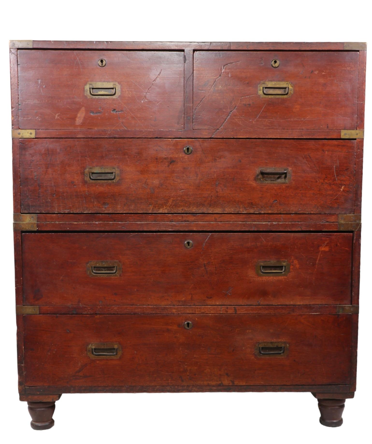 Classic two section Campaign  style chest on chest, constructed of solid wood, with brass bound corners, pulls, and eschews, and heavy iron handles. The chest features an upper section with two smaller drawers, over one larger lower drawer, which