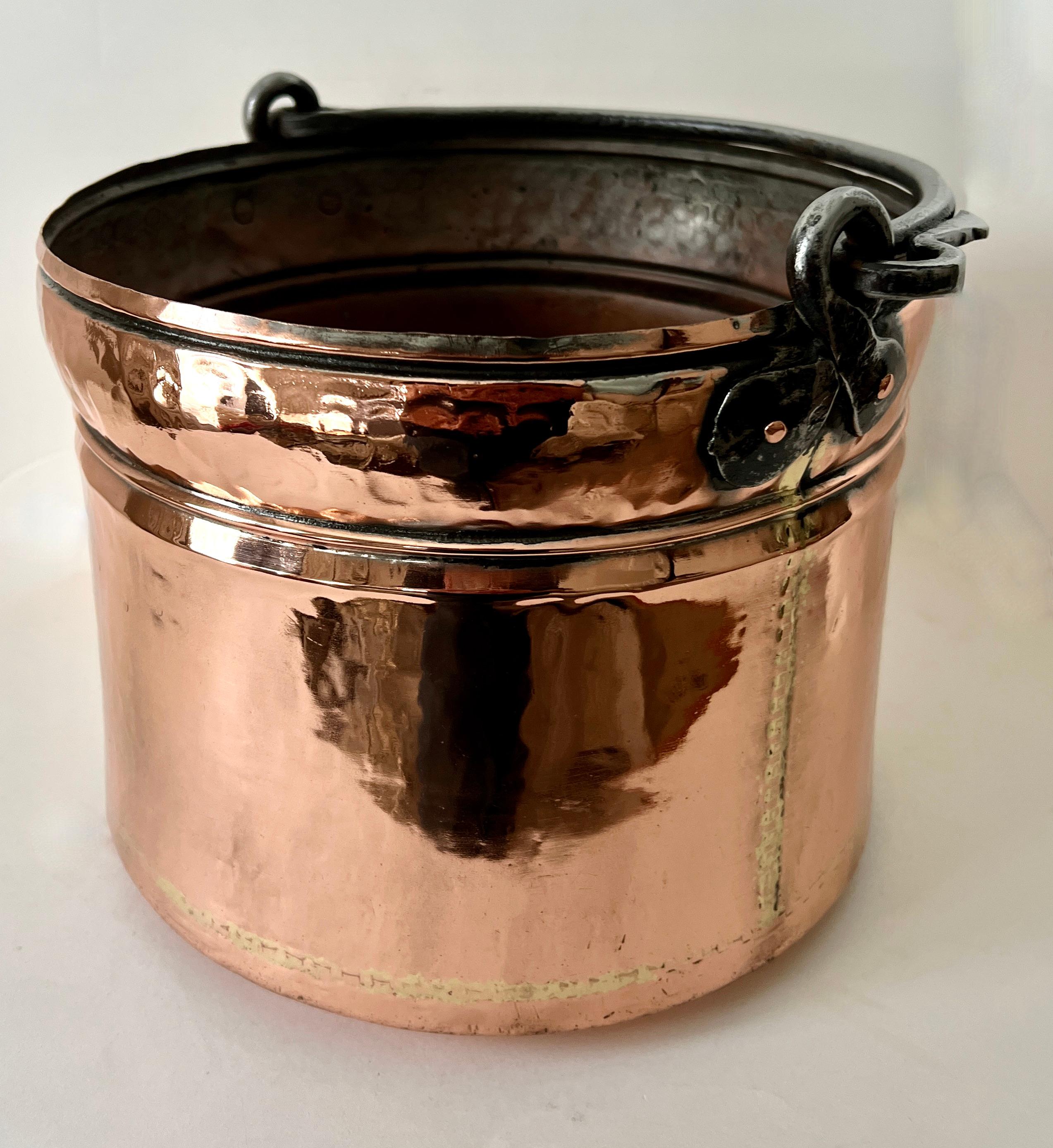 A large Copper stew pot, polished and from the 19th Century.  

The pot looks great hanging as a decorative piece in a New England kitchen or you can use it as a centerpiece, jardiniere or planter...

A compliment to many spaces and also wonderful