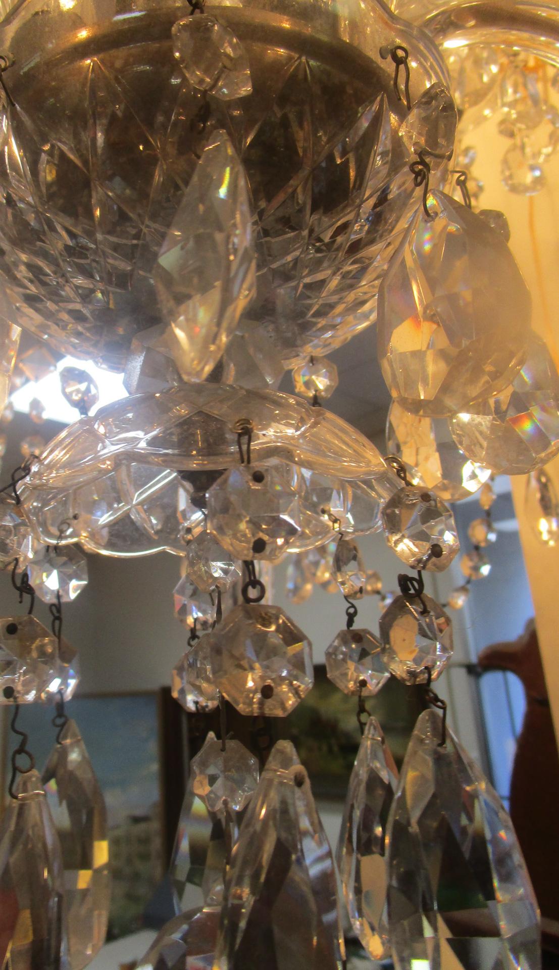 Exquisite large size well proportioned crystal English chandelier featuring ten graceful notched arms with scored double scalloped bobeche, elegant bulbous center column, two bowls and top canopy, tear drop prisms, crystal swags throughout and round