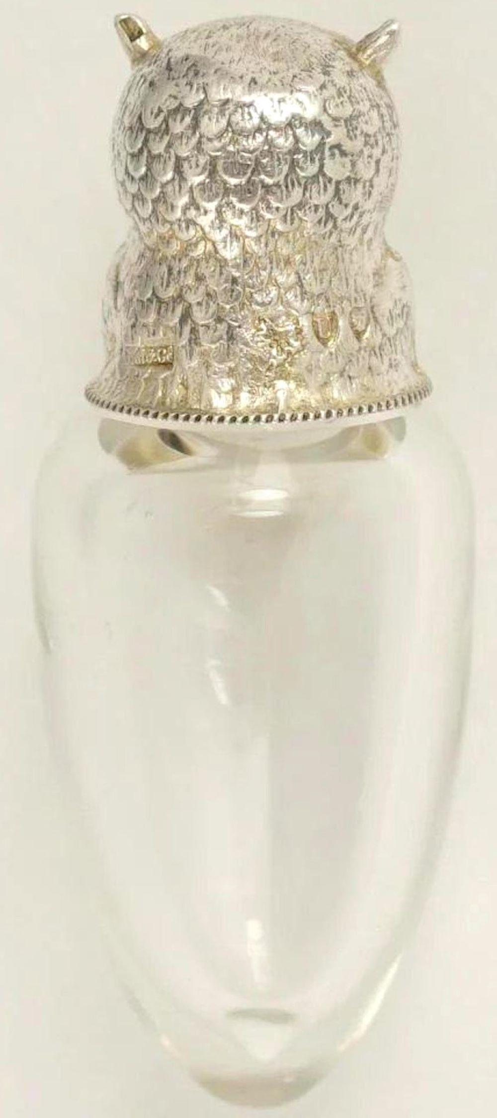 19th-century English figural sterling silver and crystal owl perfume bottle by Sampson Mordan for the French market.
An exceptional example is the owl's head, realistically cast and modeled, with a large inset of reverse painted yellow and black