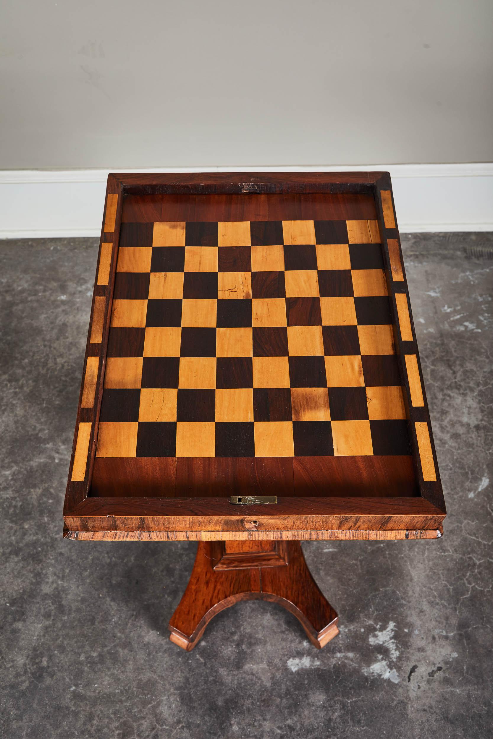 A 19th century English palisander game table. Functional side table with an inlaid chess board under the top. Beautiful palisander wood in great shape. With non-working key.