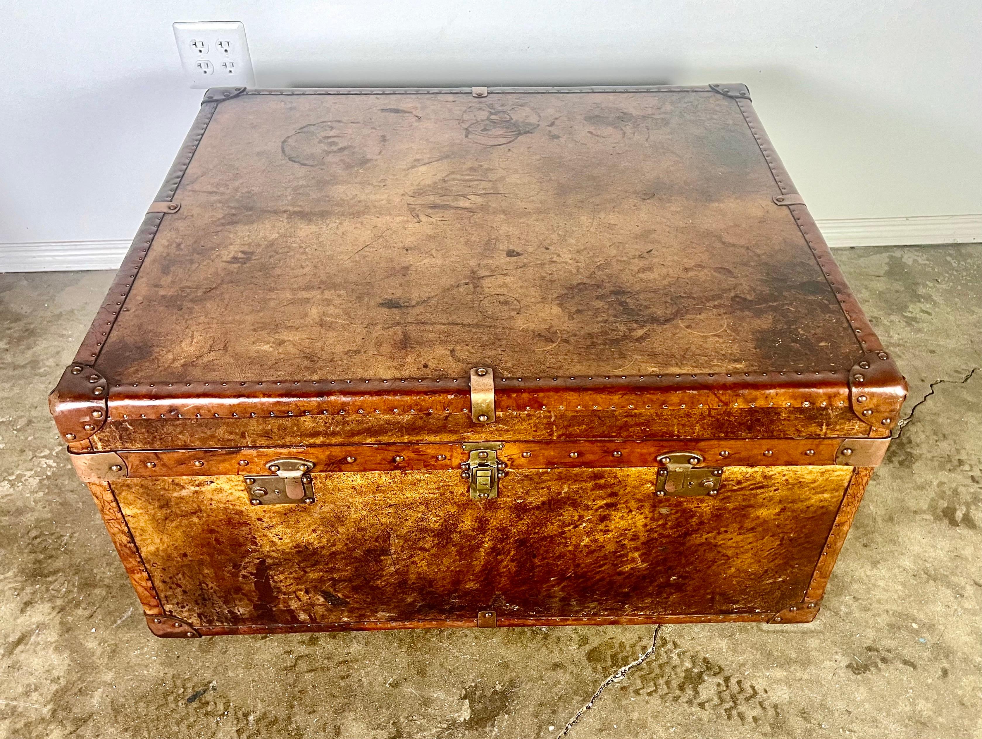 A 19th Century steamer trunk that can be used as a coffee table, featuring original brass and copper hardware, with beautifully distressed leather in good condition.  This piece is designed to embody British, English craftsmanship, set in a cozy,