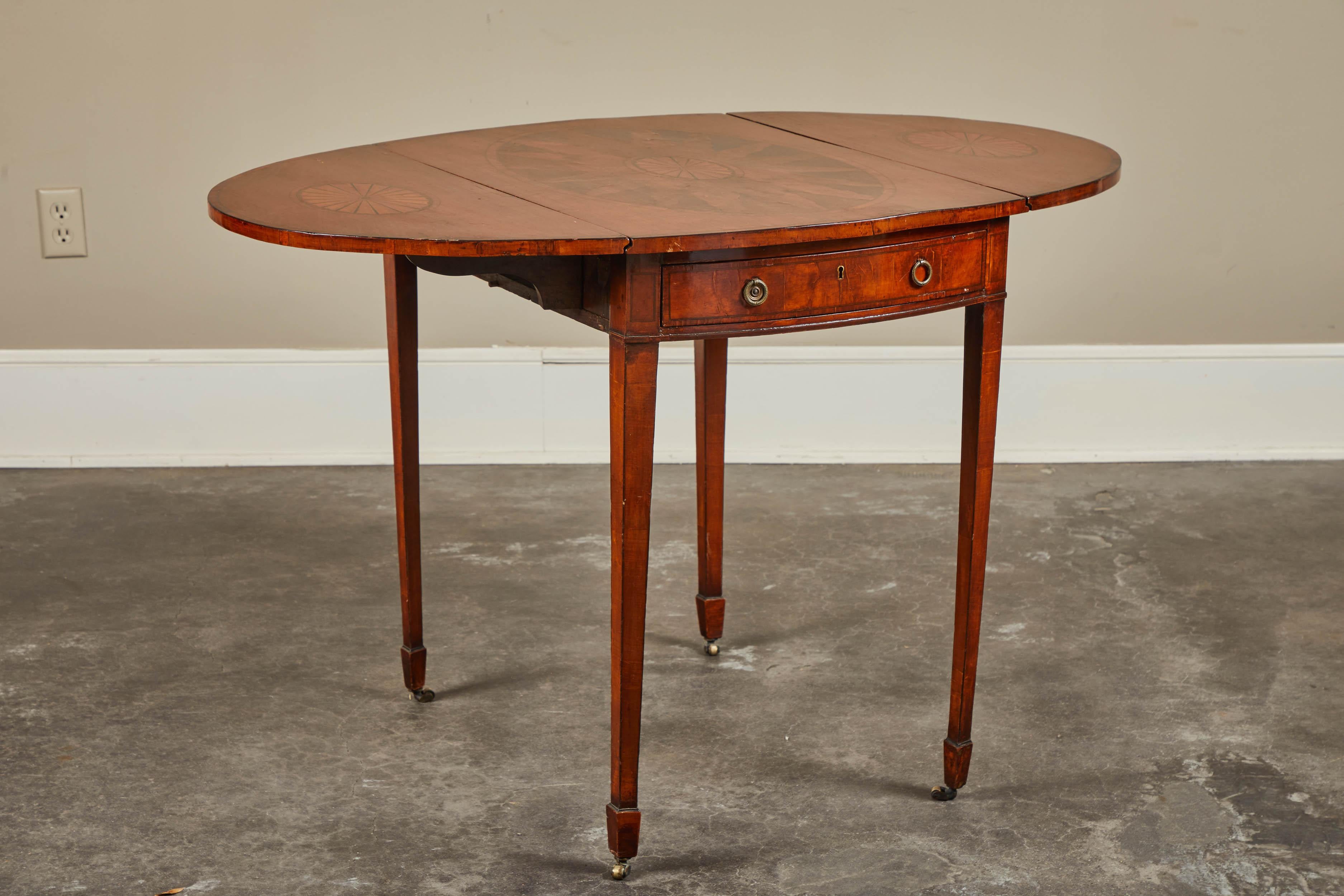 George III Pembroke table with inlaid top and drop-leaves, one working and one faux drawer, sitting on tapered legs with casters, 19th century.