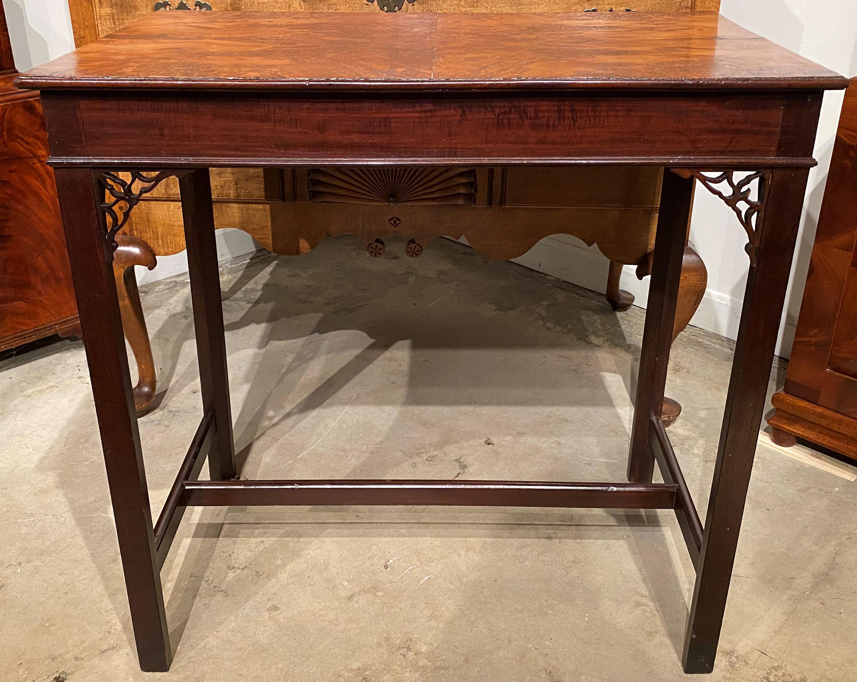 A fine example of a rectangular English mahogany tea table with fretwork leg supports, burled yew wood top, and H form base stretcher. The table is in very good condition, with a few minor losses on the fretwork and edges, and wear commensurate with