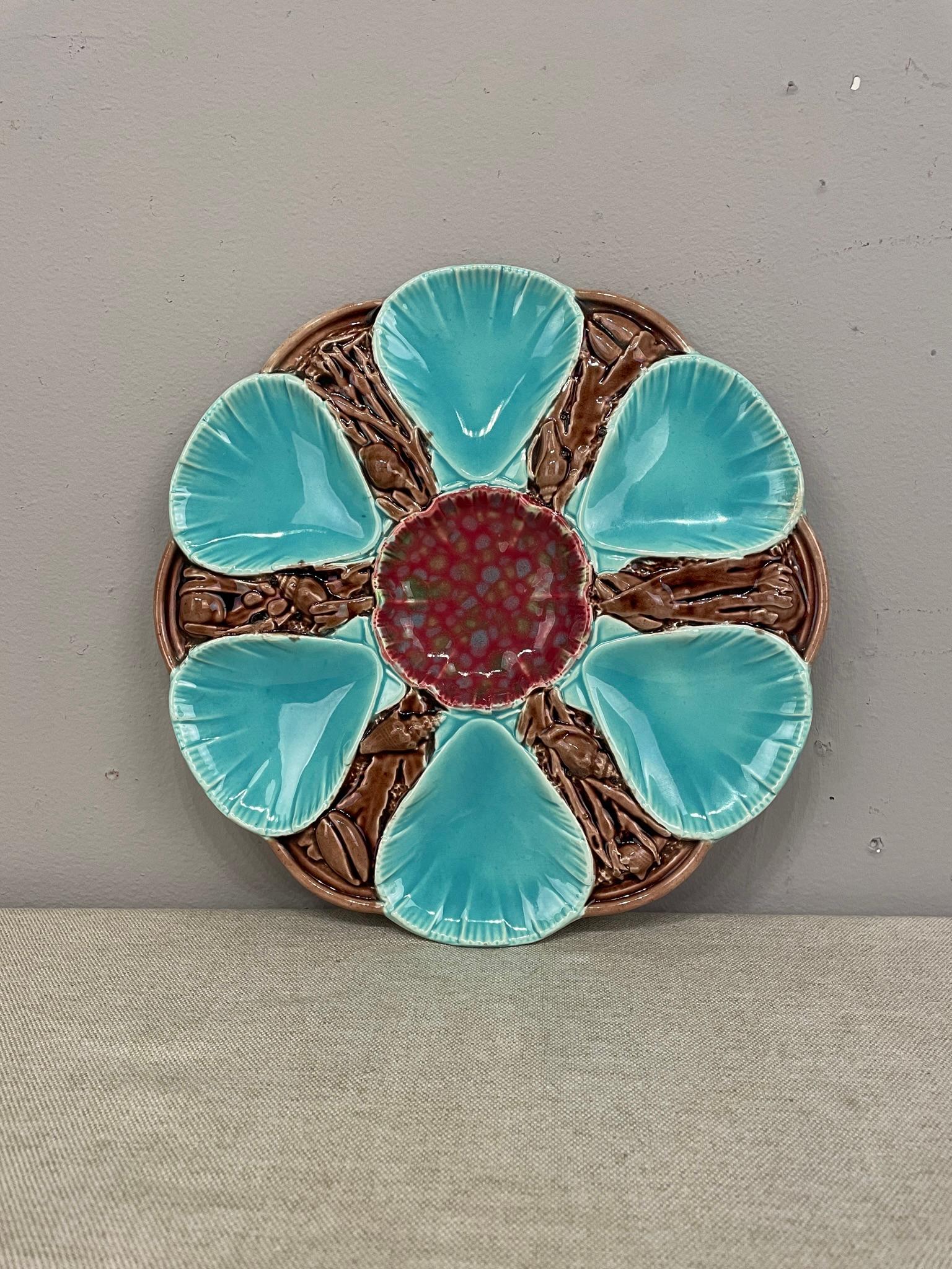 A late 19th century English Majolica 6 wells turquoise Oyster Plates with a center well. No damages noted. Dimensions are 9.75