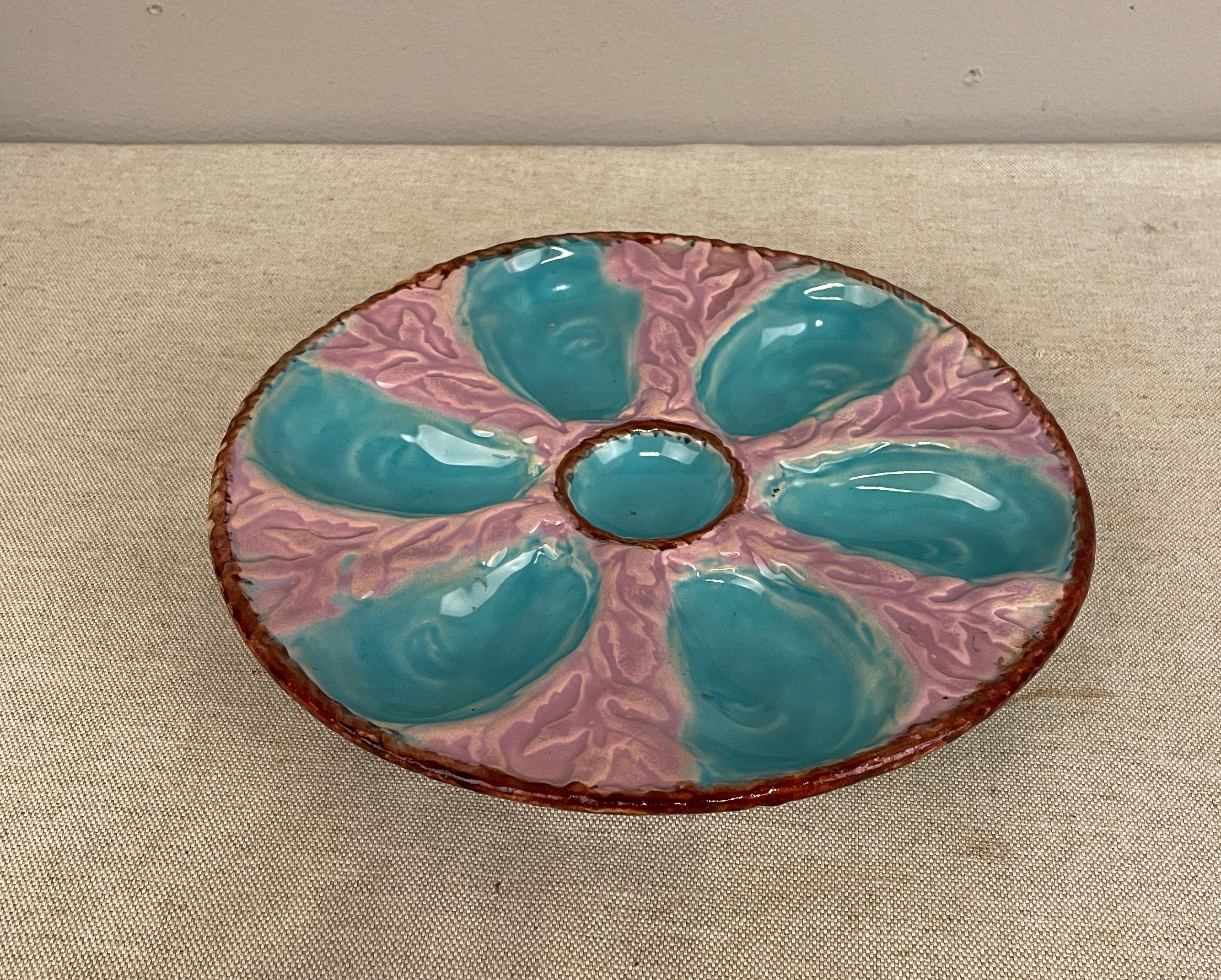 A 19th c English Oyster Plate with six-well majolica glazed oyster plate by Fielding & Co. Ltd., Stoke-on-Trent, England, circa 1875-1880.. Turquoise oyster wells surround a center well. A chocolate brown nautical rope border encircles the center