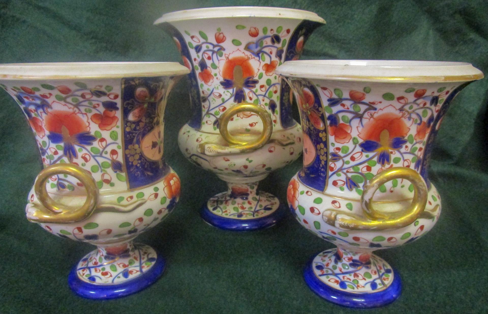 This lovely set of three English Mason's Ironstone Regency period jardineres with 
handles are decorated in the vivid Japonesque Imari colors and pattern. The two smallest urns measure 7 inches tall x 5.50 wide x 5.50 deep. The tallest is 8.50