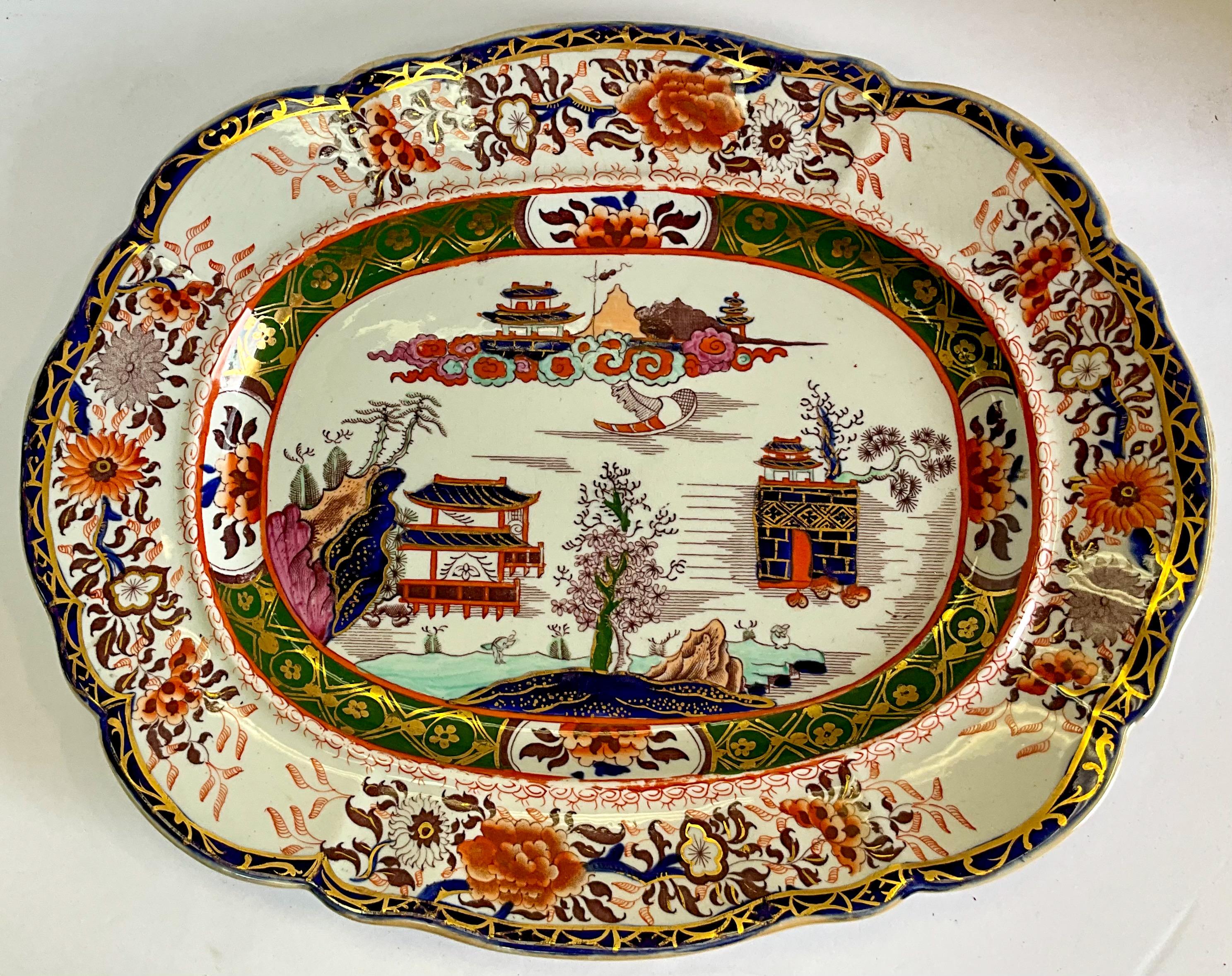 This is an early English Mason’s Ironstone platter. It has Imari coloration chinoiserie inspired themes throughout. It is marked. There are two available. 

Please note the turquoise on one is slightly lighter than the other.