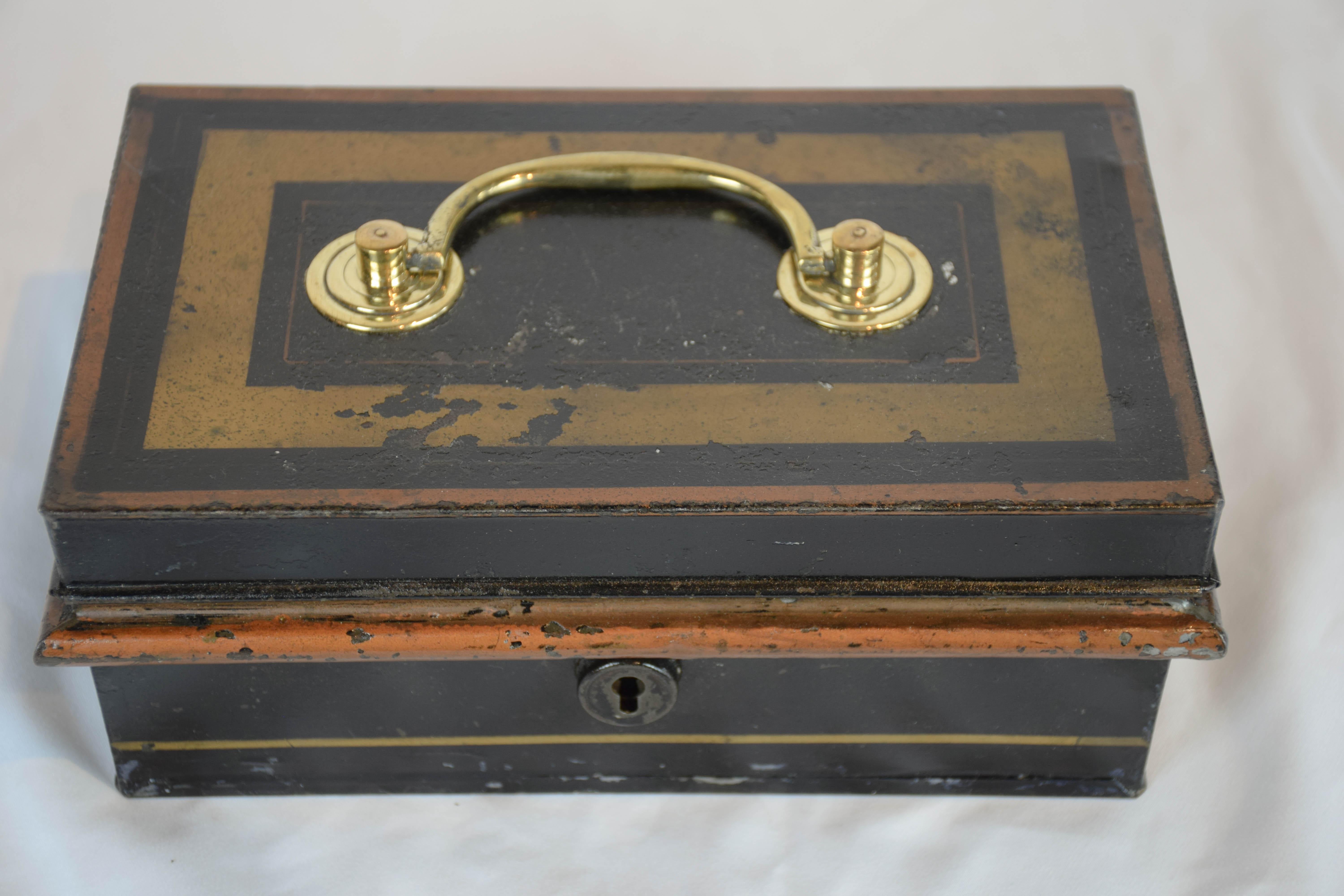 This 19th century English cash box is all original including the key. The box when open has an insert with 2 compartments with hinged lids and a handle. It has a beautiful painted patina.