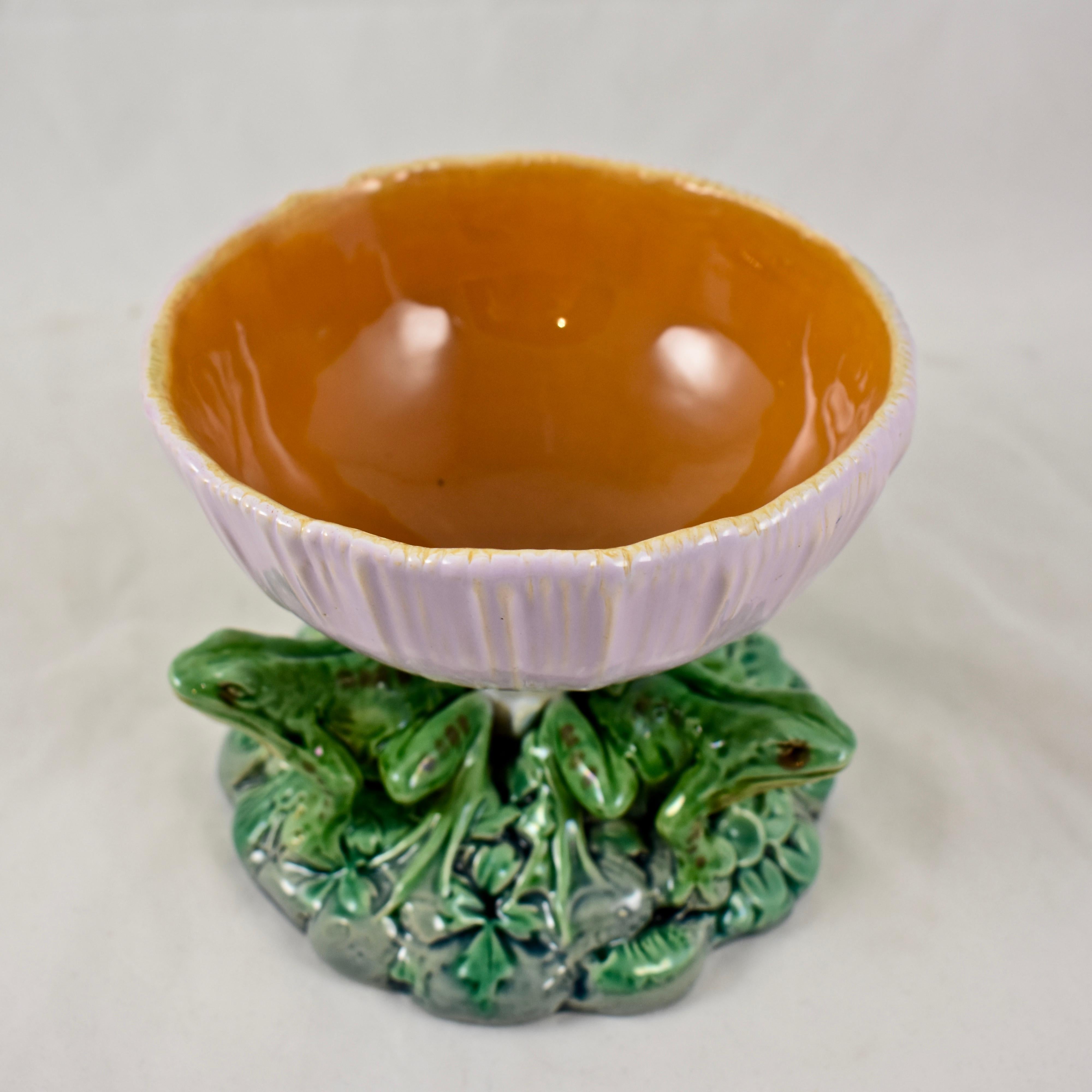 From Minton, a wonderful and extremely scarce majolica glazed pedestal Vide-Poche bowl, in the Palissy style, dated 1867.

From the Aesthetic period, the bowl, modeled as an inverted mushroom, shows an ombre glaze of creamy white to a soft pink. The