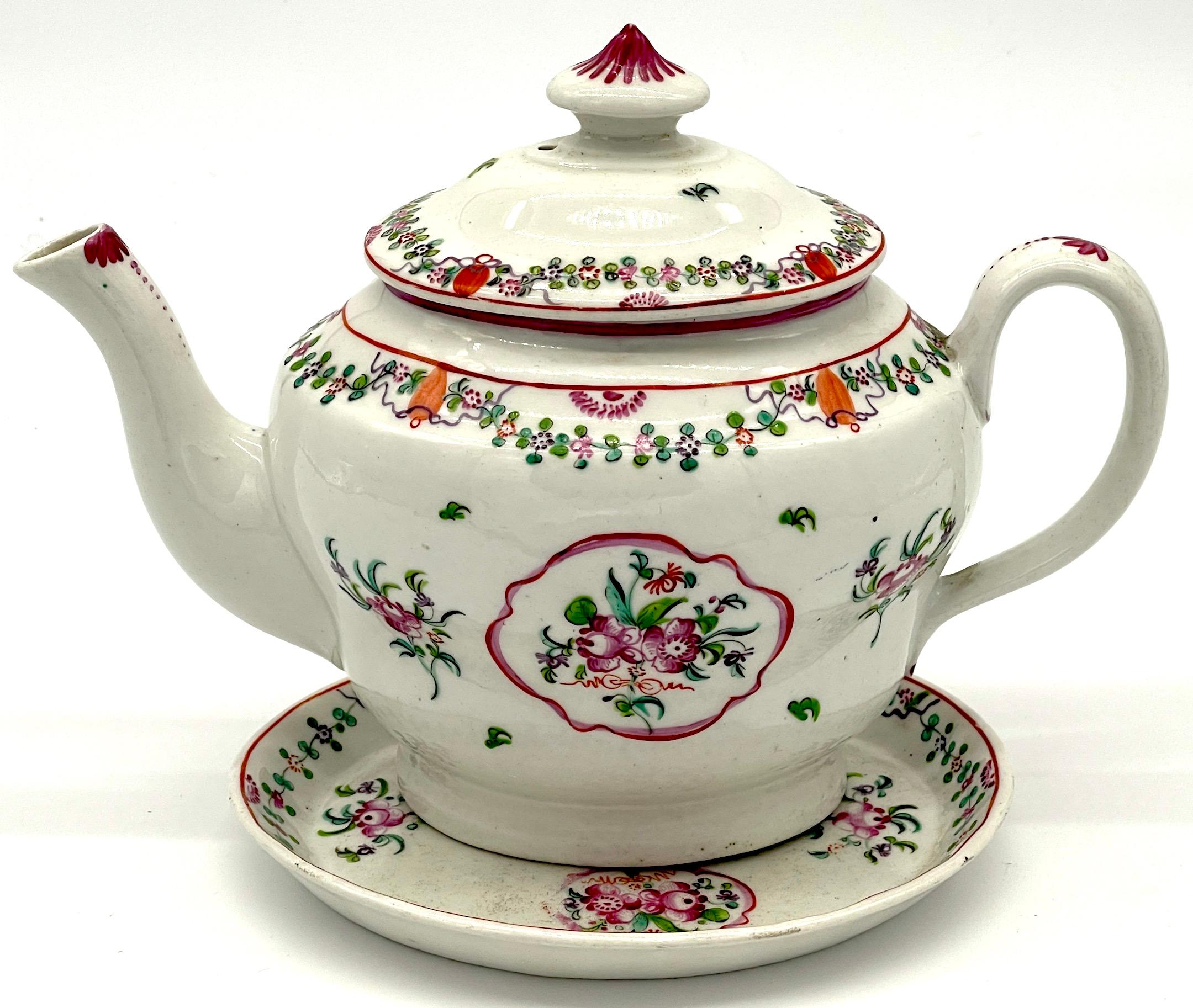 19th C English New Hall Hand Painted Teapot & Trivet, Chinese Export Style

This is a rare and exquisite surviving pair of early 19th-century English porcelain tea articles,  featuring a teapot and a matching porcelain teapot stand or trivet. Both