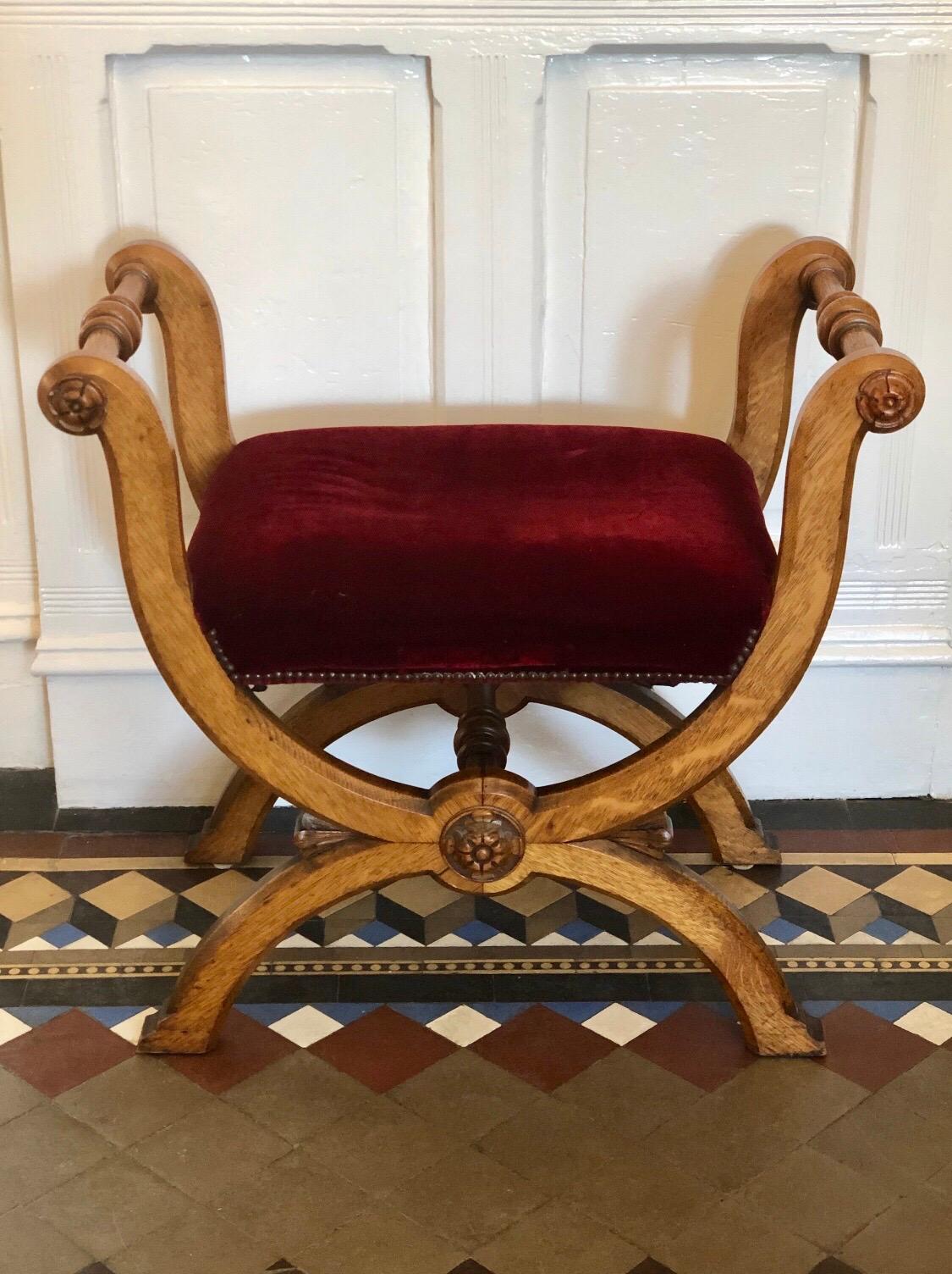 This English Country house bench is solid oak in the Classic Curule design. This window bench has a warm oak patina and rich red velvet seat.

Measures: Seat height 19.75