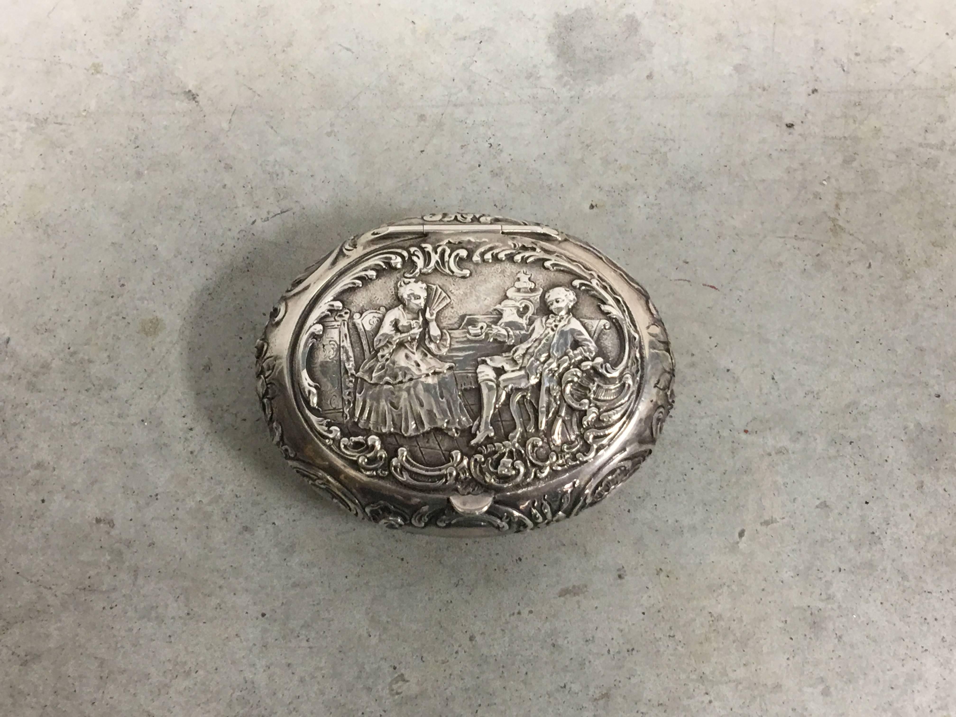 Offered is a stunning, 19th century English sterling silver oval snuff box. Lovely, traditional European relief-effect design all-over. The piece is hinged along the upper backside, allowing the top to pivot open. Marked on underside.