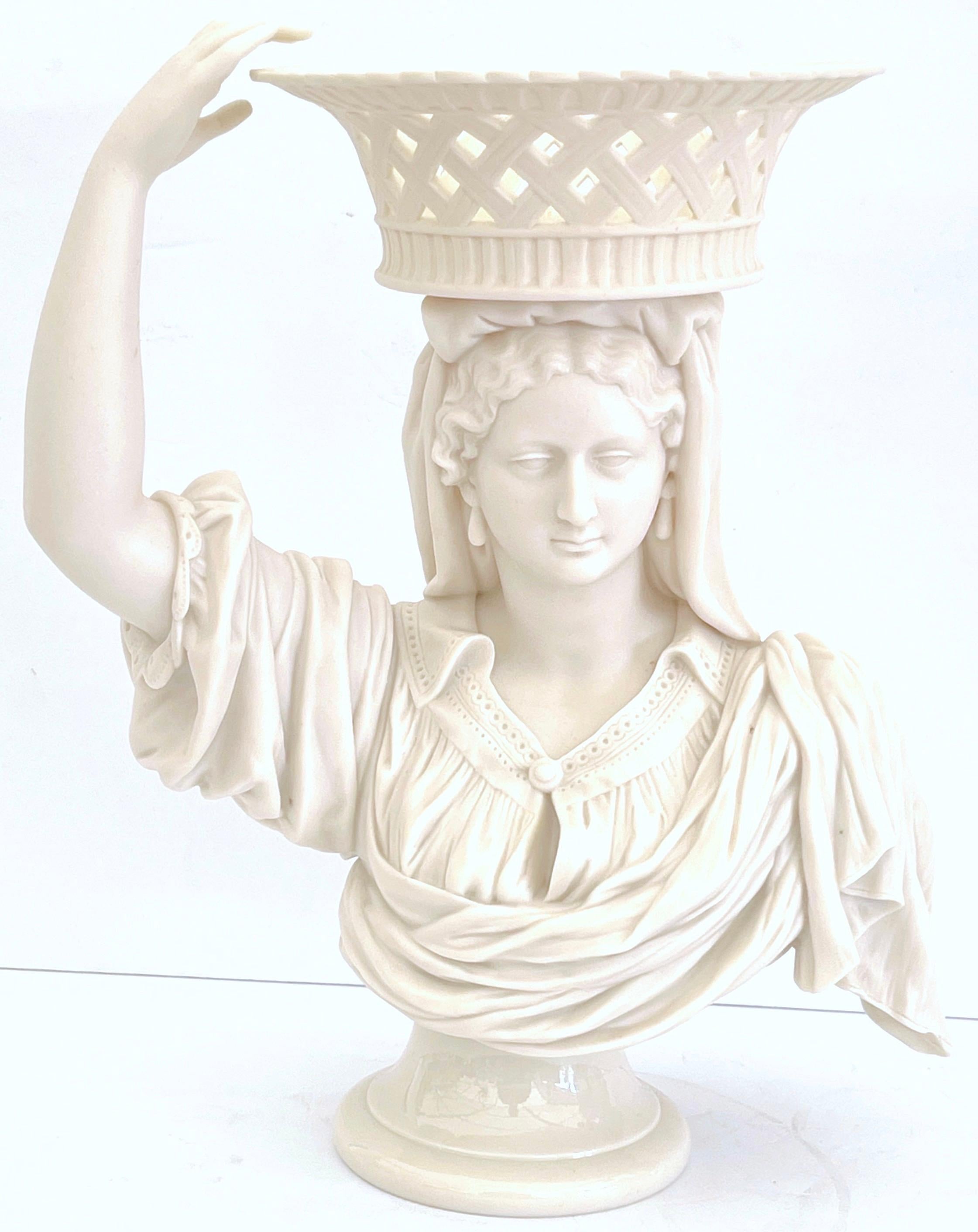 19th Century English Parian Lady Holding a Basket Centerpiece/ Tazza/ Vase 
Unmarked, Attributed to Copeland 
A stunning 19th Century English Parian Lady Holding a Basket Centerpiece, attributed to Copeland, although unmarked. This remarkable piece
