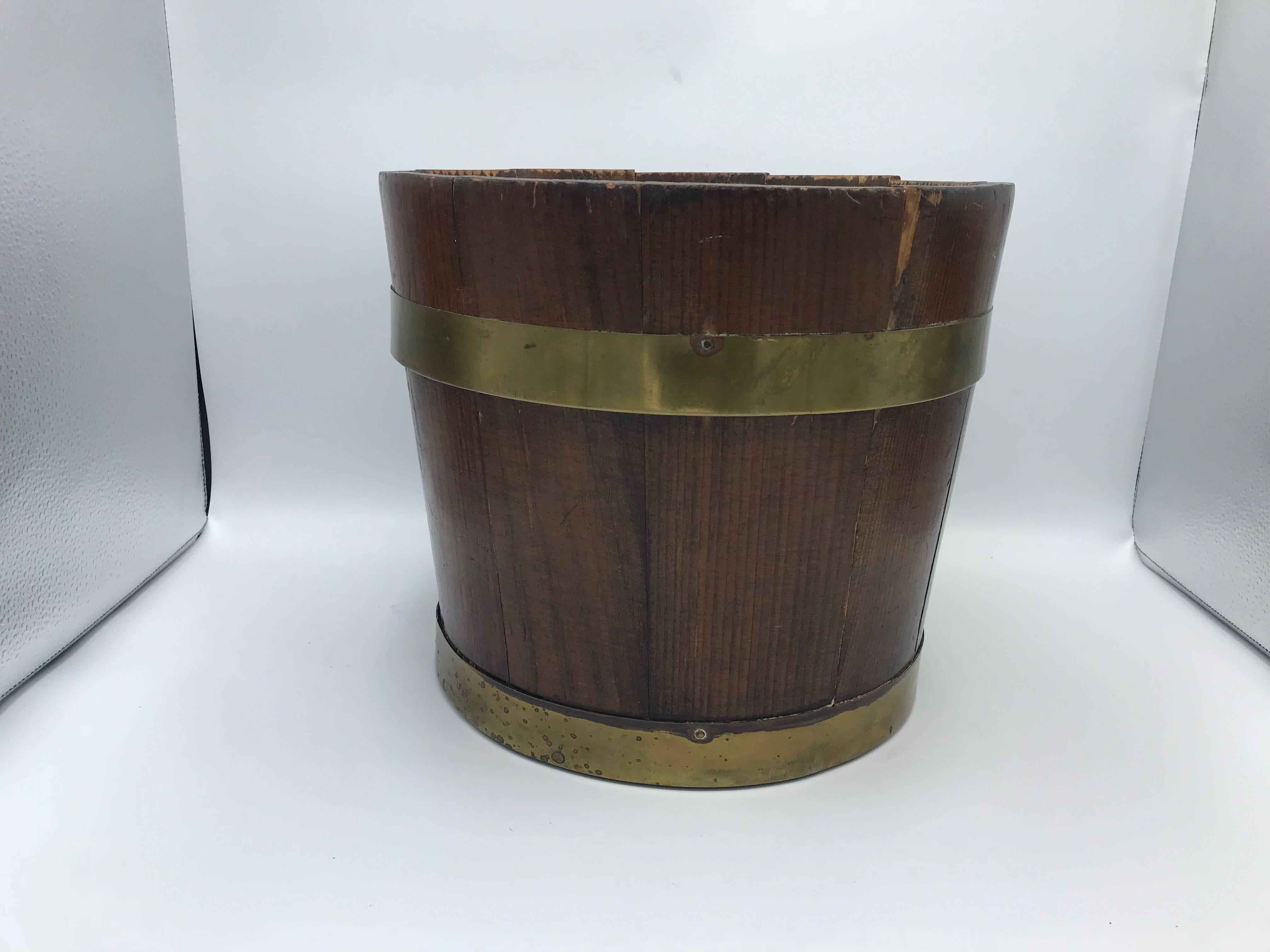 Offered is an exquisite, late 19th century English pine bucket with a brass banded collar. Could be used as a cachepot planter, centerpiece, or waste bin with appropriate liner. Lovely all-over patina to brass.
