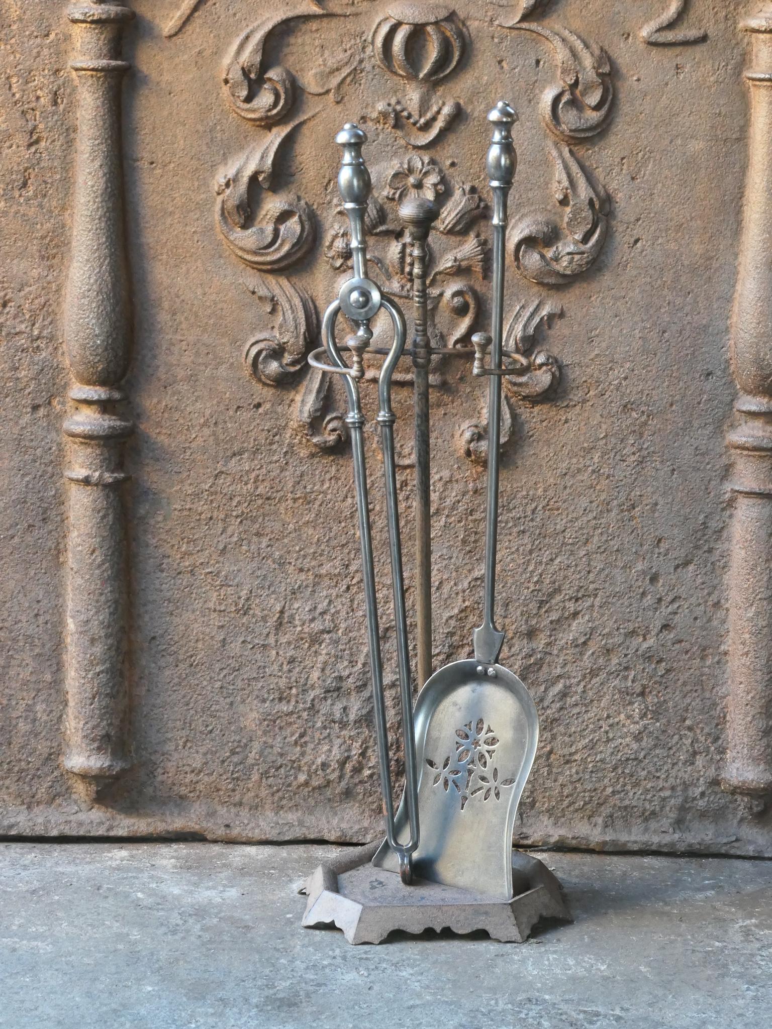 19th century English Victorian fireside companion set. The tool set consists of thongs, shovel and stand. Made of brass (stand) and polished steel (fire irons). It is in a good condition and is fully functional.