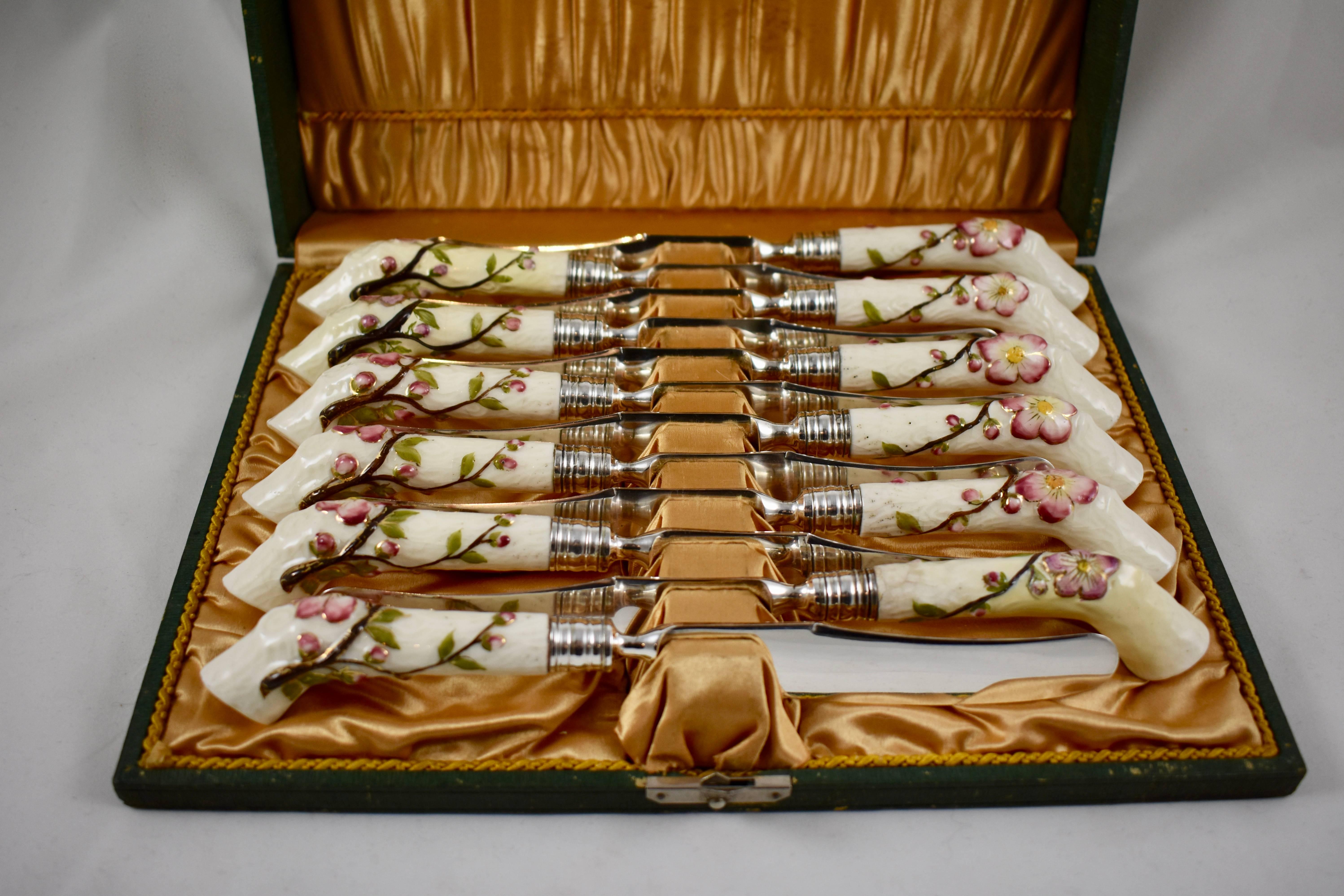 A scarce set of 12 boxed porcelain handled dessert knives, circa 1860-1870, attributed to Royal Worcester, Staffordshire, England, and retailed by Richard Briggs of Boston.

The bent crabstick handles are twined with gilded apple blossoms and are