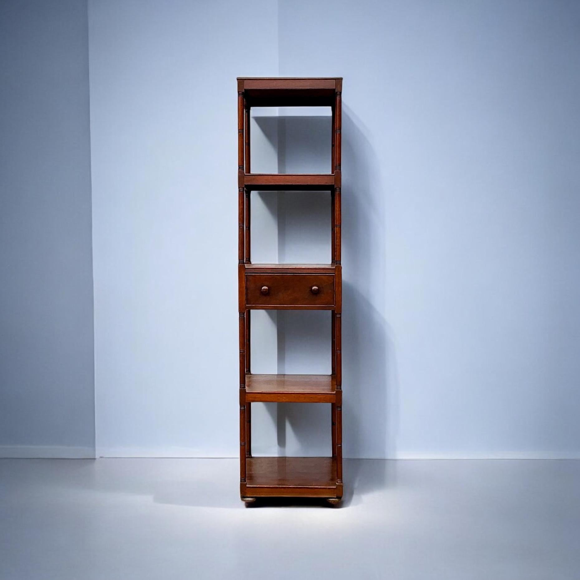 This is a late 19th century Regency carved mahogany etagere. It has four tiers with a single drawer and turned bun feet. This timeless piece would work well in both modern and traditional decor. 

Shipping can run two to five weeks, but this might