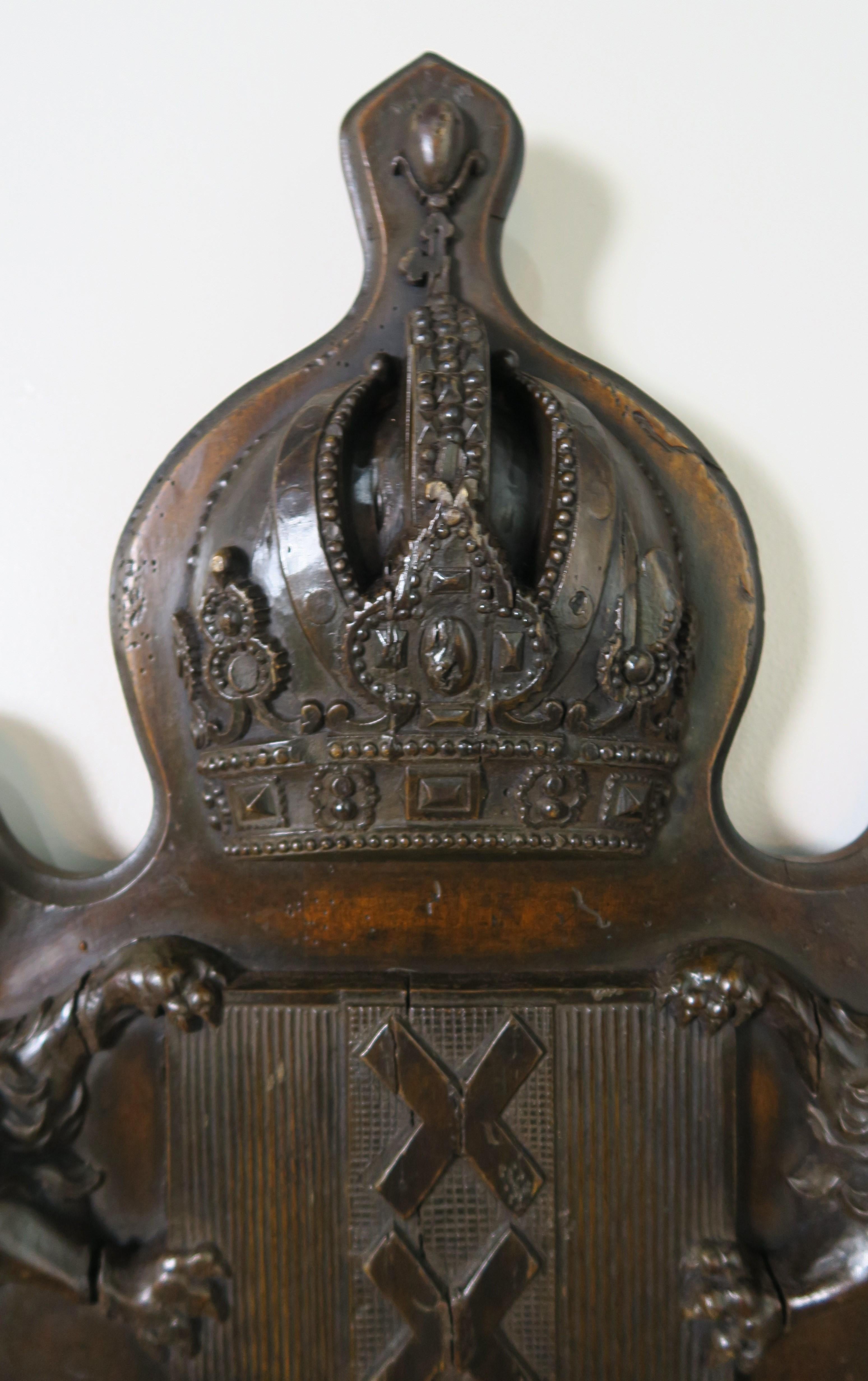 19th century plaque of a walnut family crest depicting a pair of lions flanking a center crest with a triple 