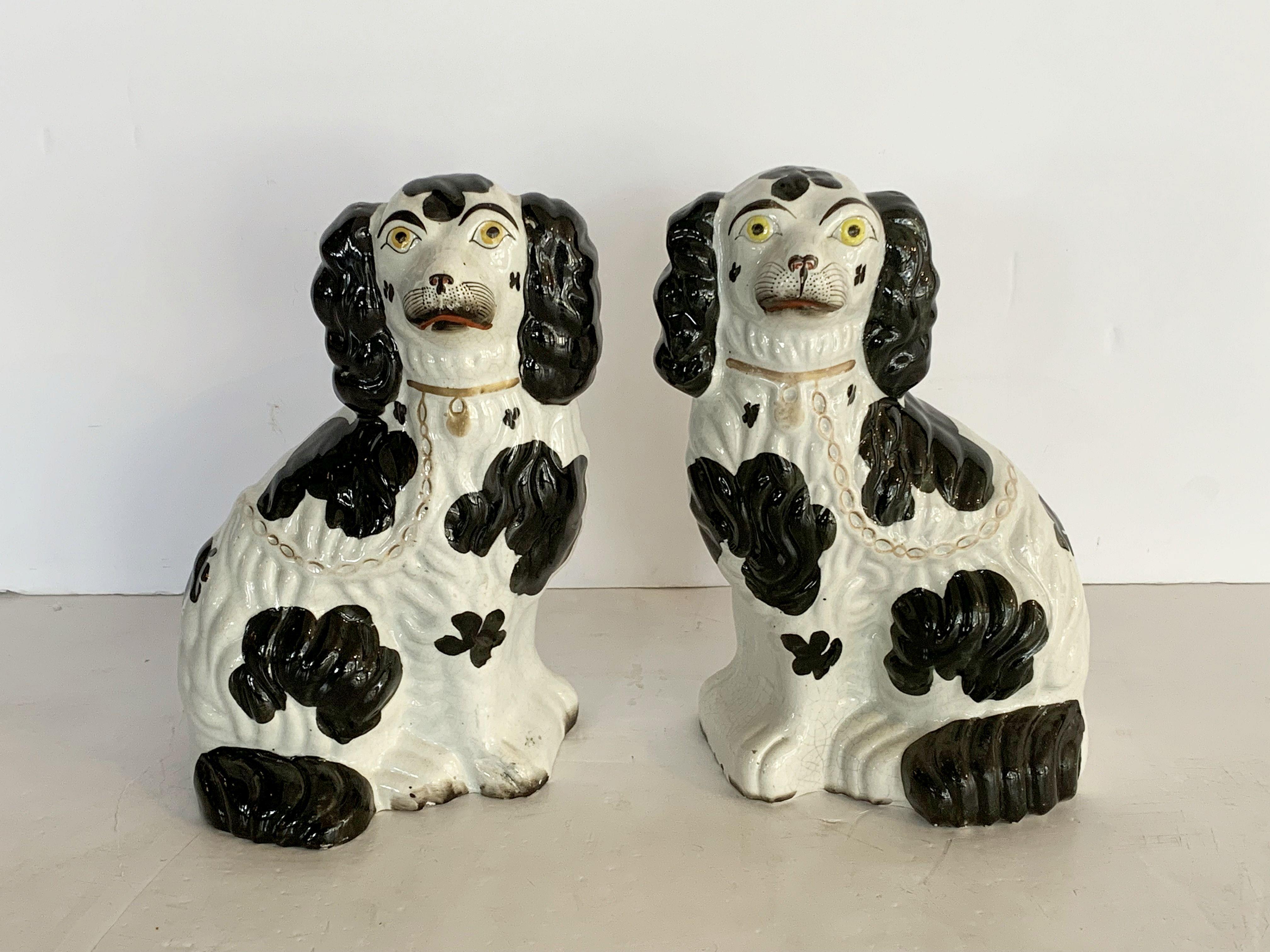 A handsome pair of 19th century. English King Charles spaniels from the Staffordshire Potteries. 

Also known as comforter dogs, this pair is from the early period of production - the high mark era known for its Fine attention to modeled detail,